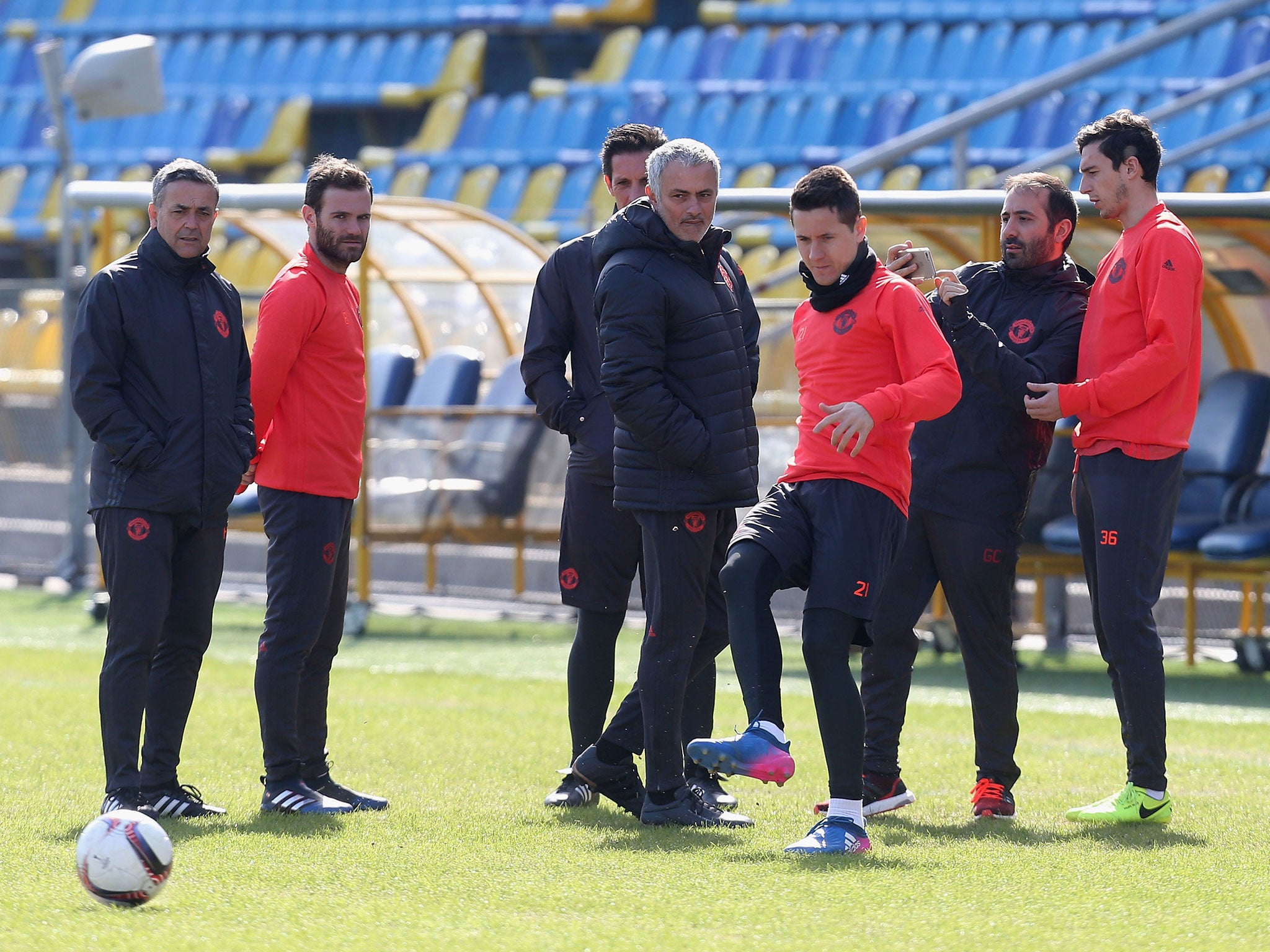 Jose Mourinho with his players as they test the pitch at the Olimp-2 Stadium