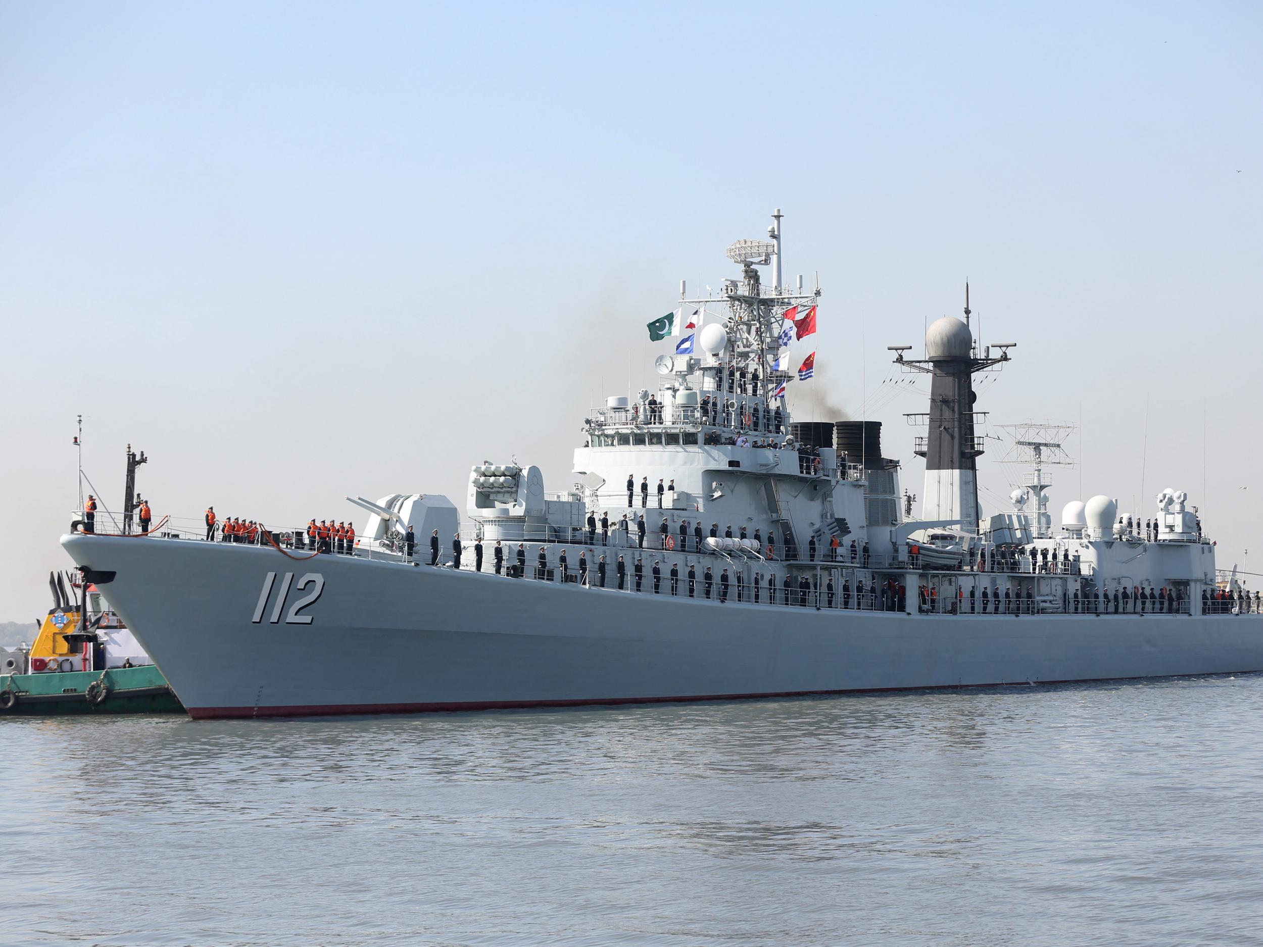 Chinese servicemen standing watch on the deck of a naval vessel