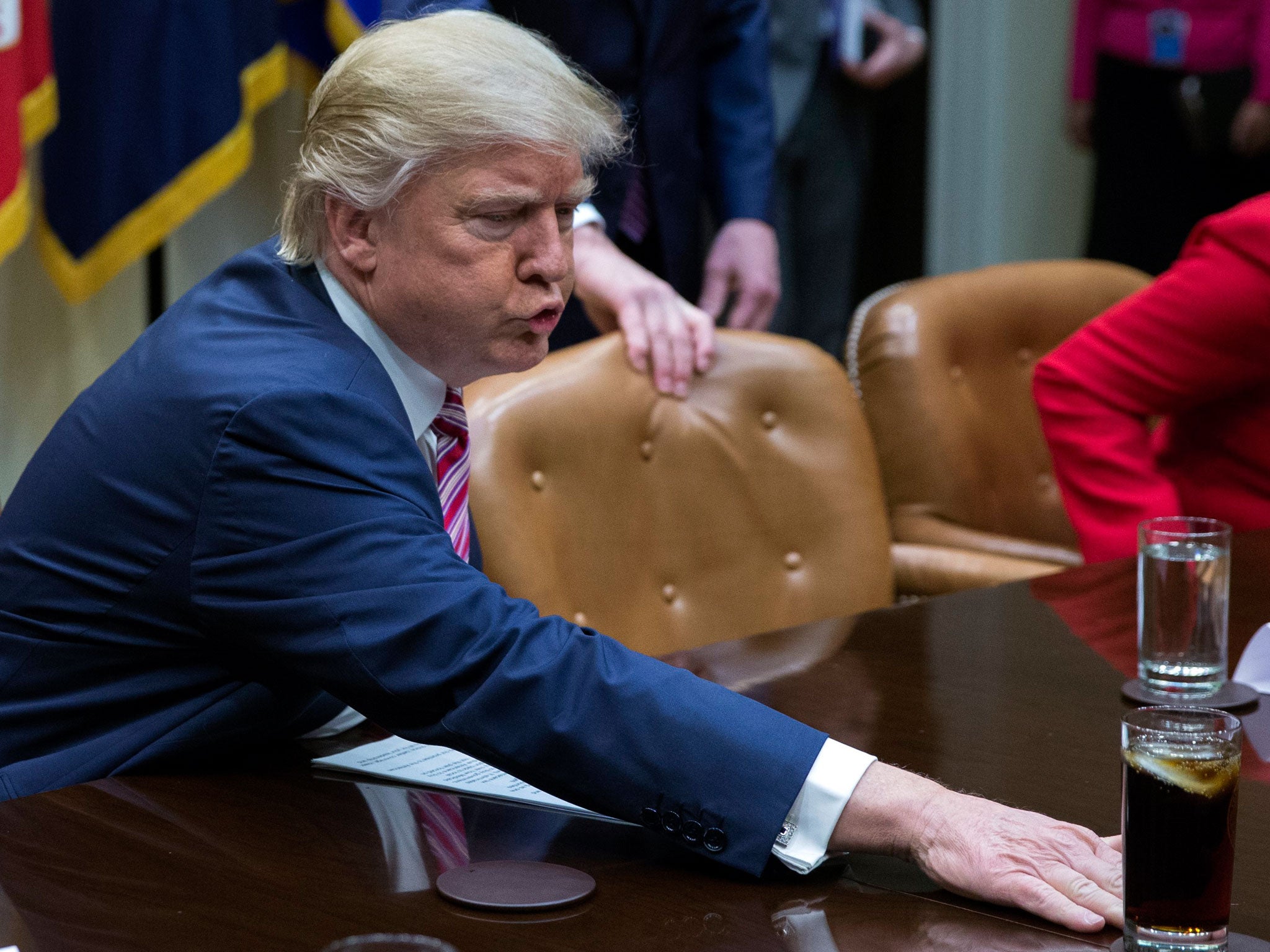 Donald Trump moves a drink across the table prior to participating in a health care discussion with House Energy and Commerce Chairman Greg Walden