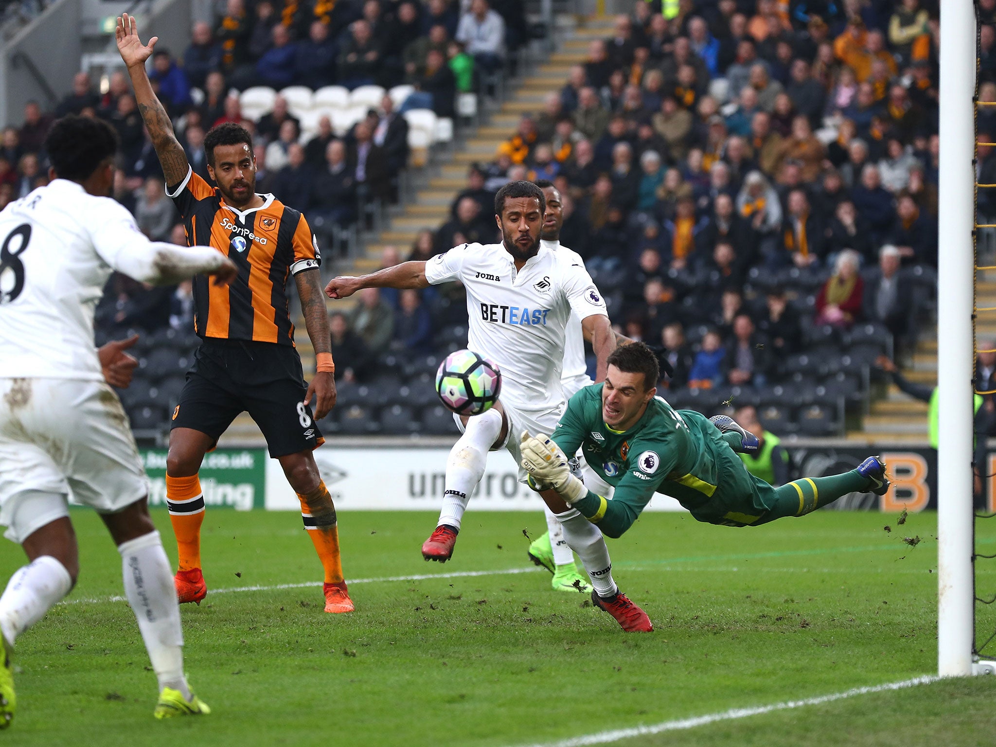 Eldin Jakupovic punches away an attempted shot on goal from Wayne Routledge