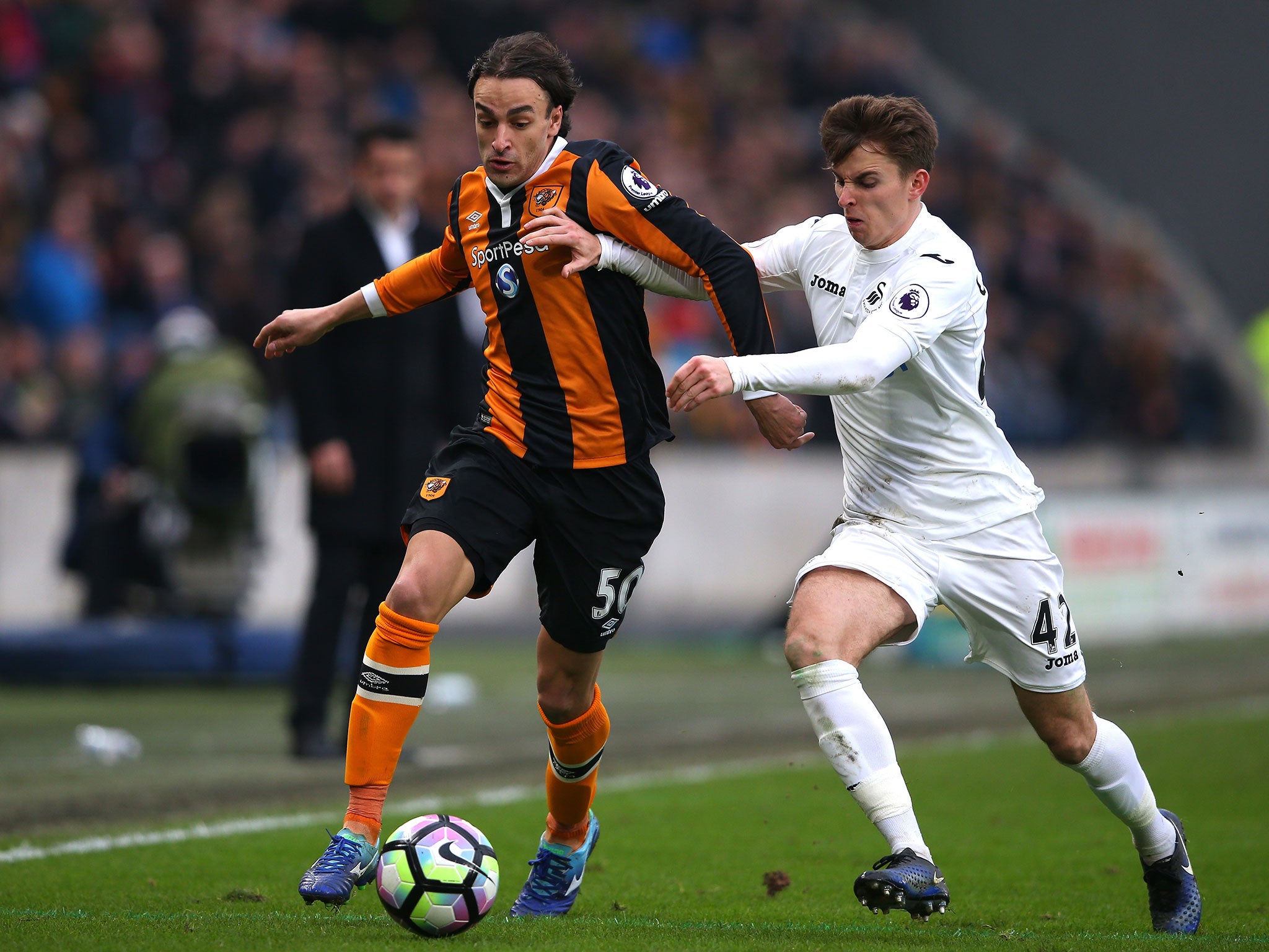 Lazar Markovic and Tom Carroll vie for possession