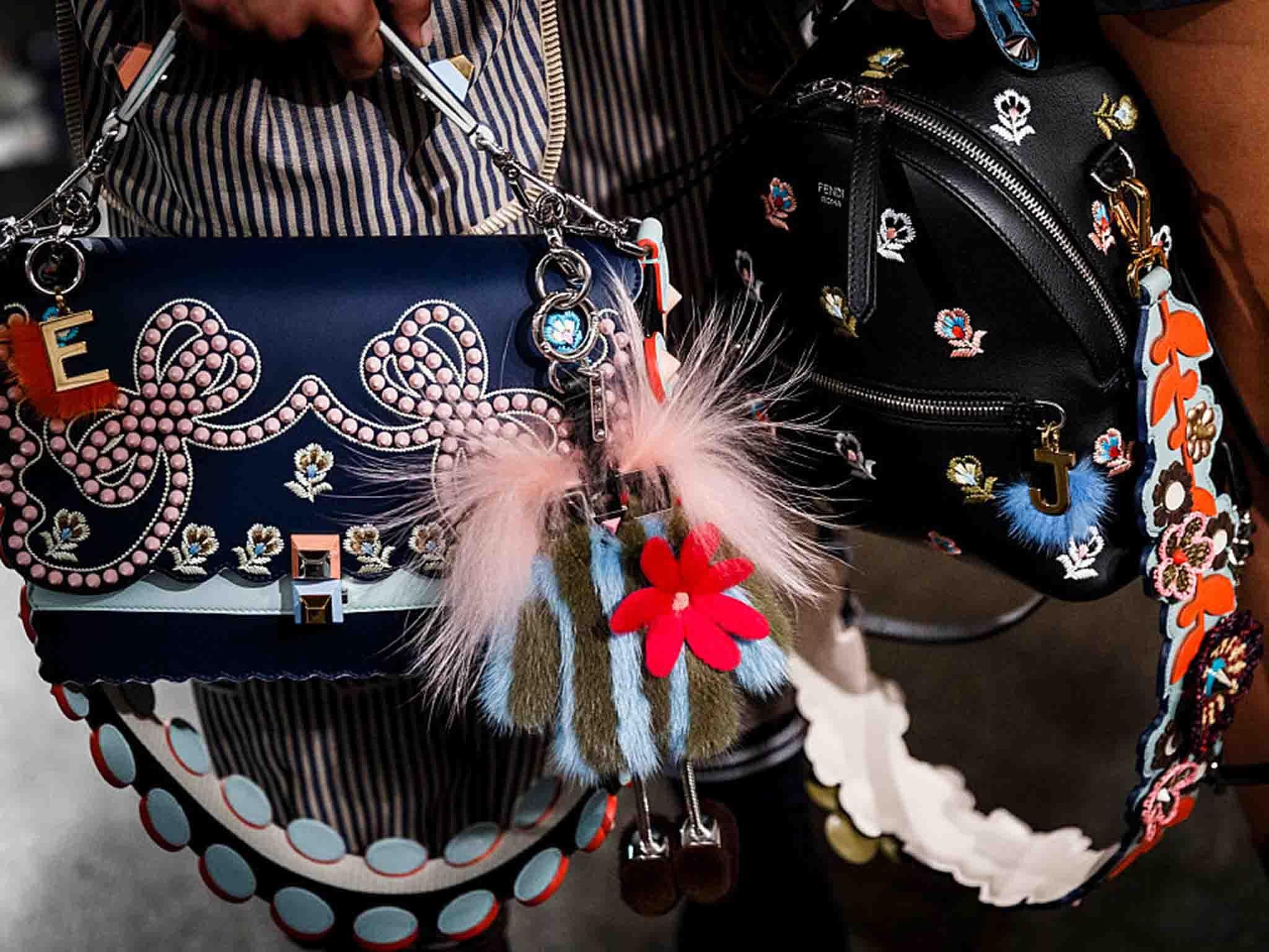 At Fendi, little frame bags were decorated with a clutter of key fobs and furry pom poms