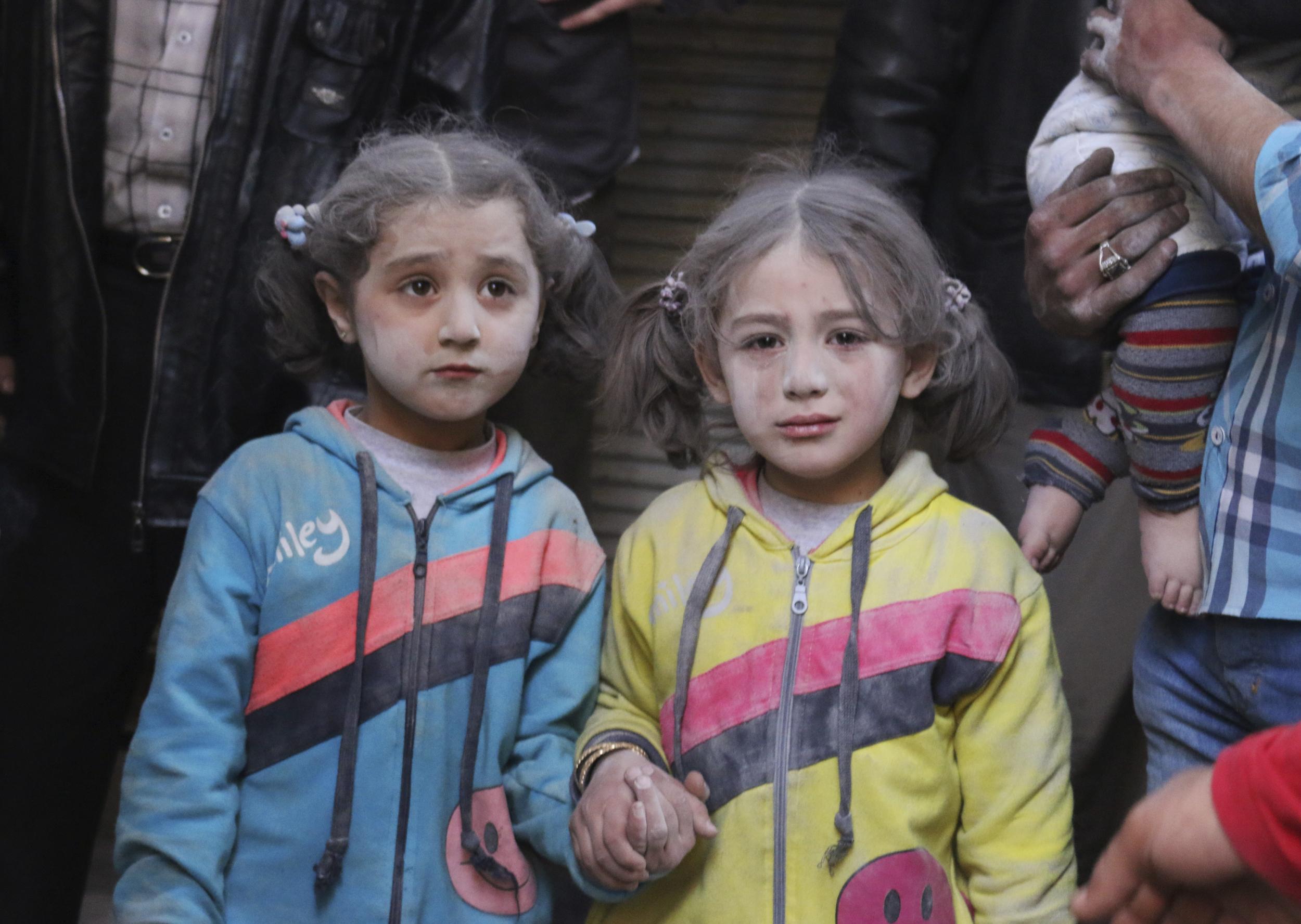 Girls who survived what activists said was a ground-to-ground missile attack by forces of Bashar al-Assad