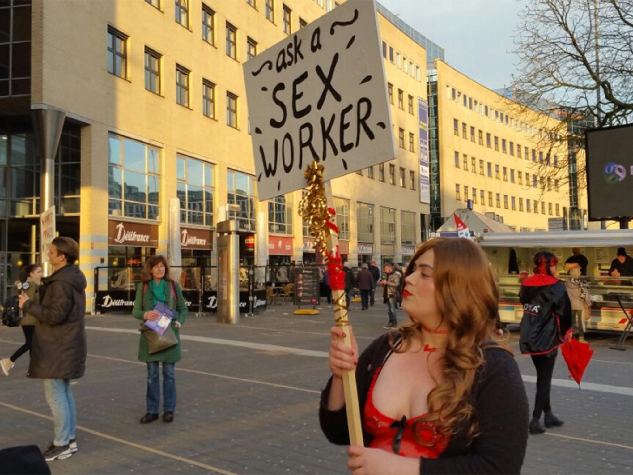 A member of Proud raises awareness of sex work in a street in Amsterdam