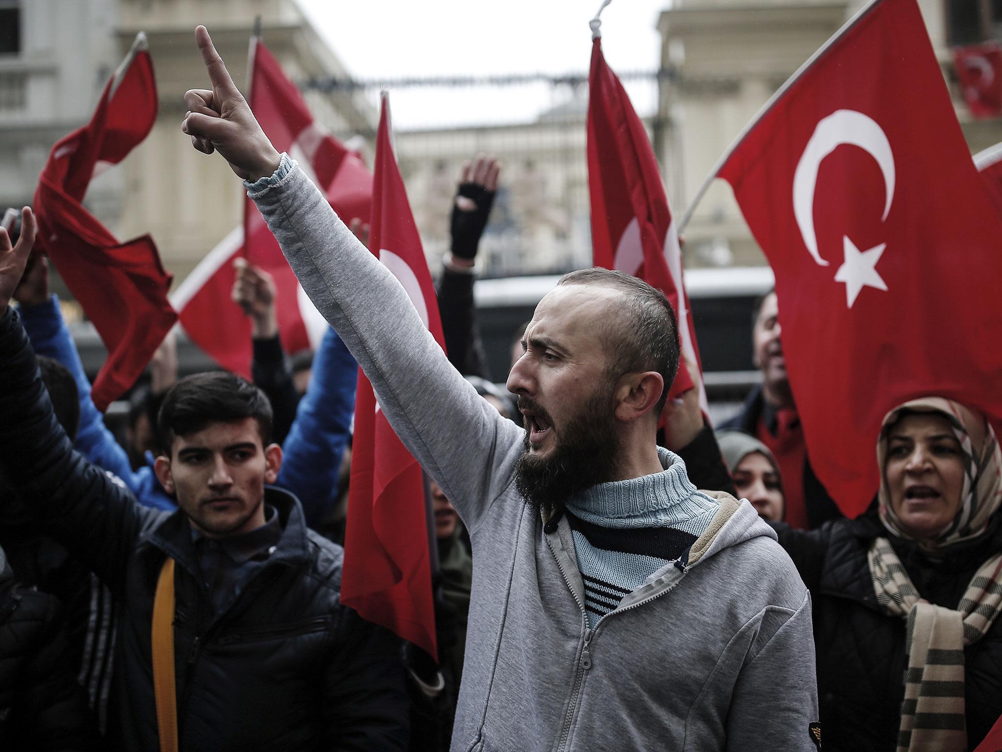 Dutch police used dogs and water cannons to disperse hundreds of protesters who gathered outside the Turkish consulate in Rotterdam