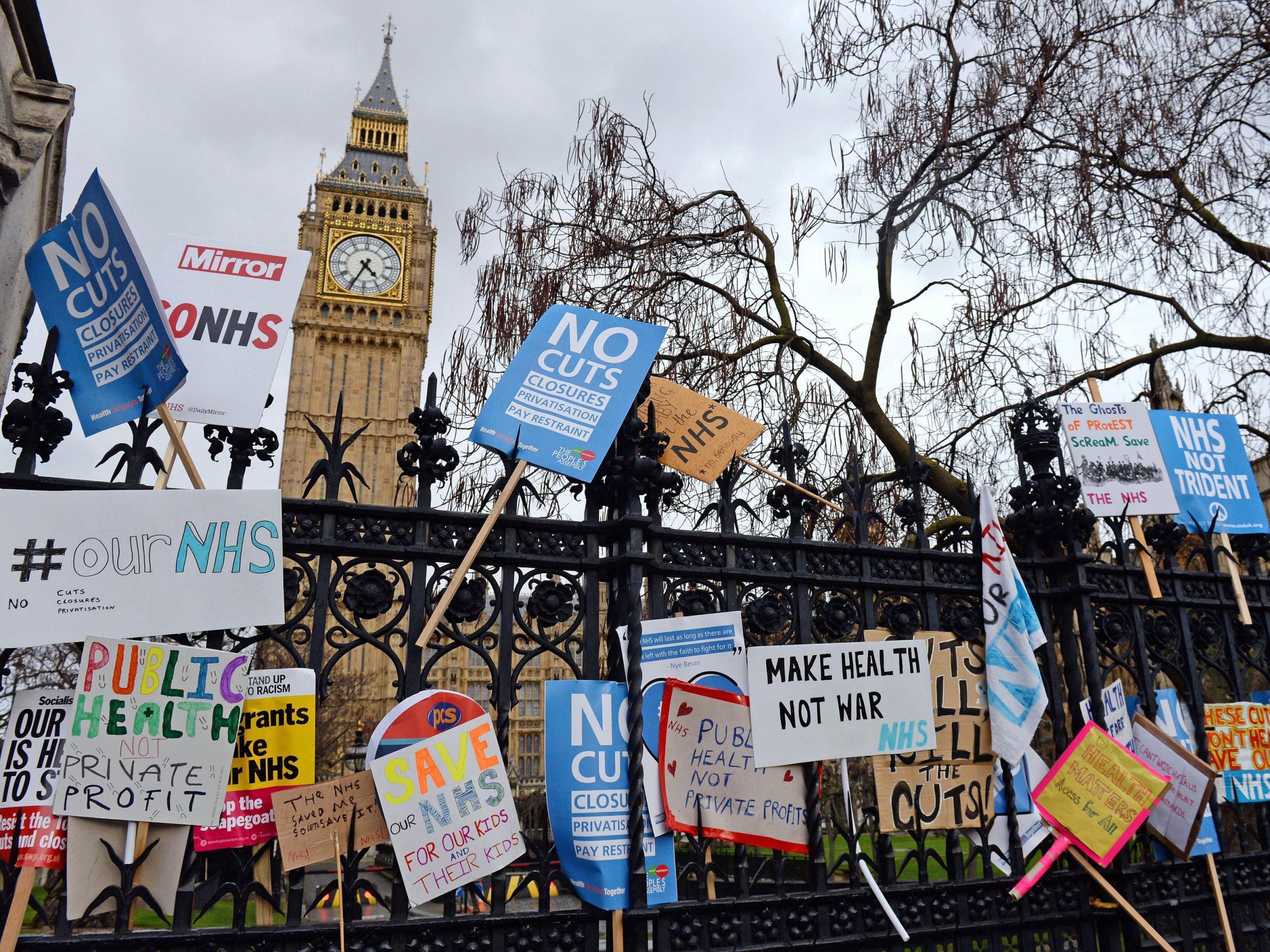 Placards left outside the Houses of Parliament after a rally in support of the NHS