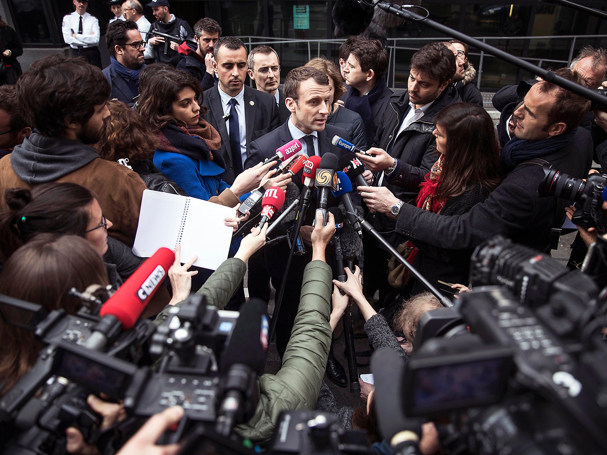 French presidential candidate Emmanuel Macron of the 'En Marche' political movement speaks to members of the media after visiting a police station within his election campaigning in Paris