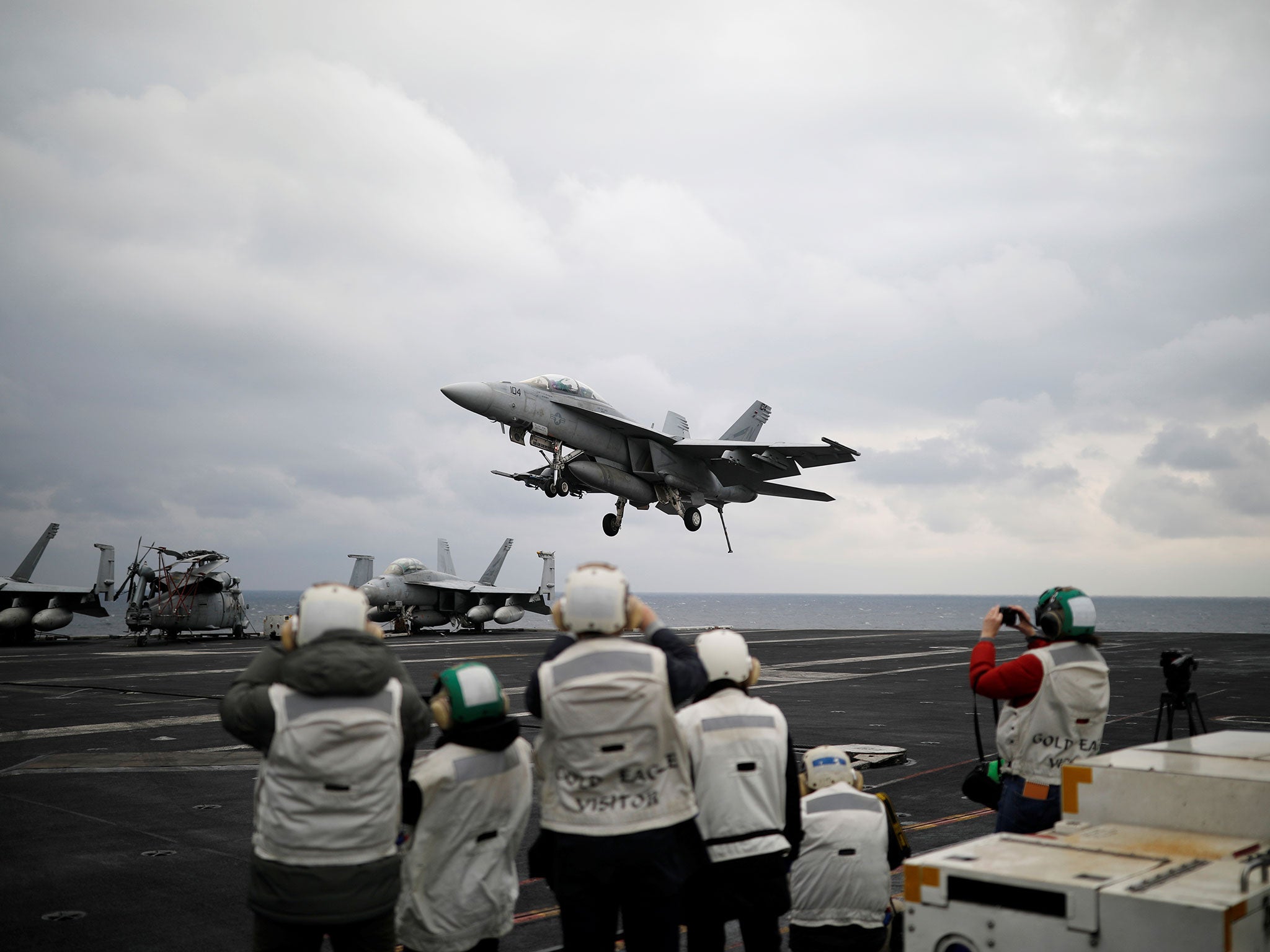 A US F18 fighter jet lands on the deck of the aircraft carrier USS Carl Vinson