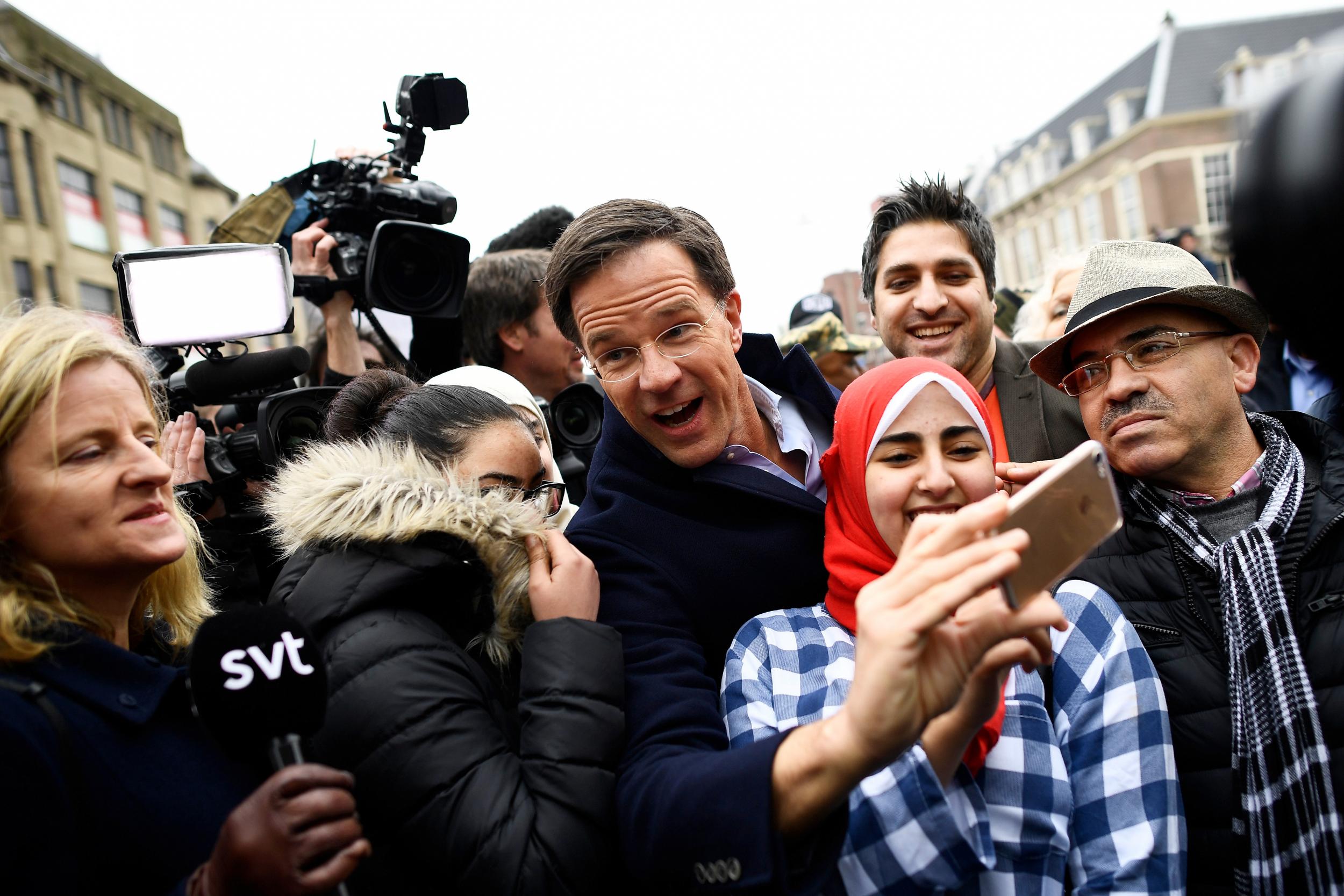 Dutch Prime Minister Mark Rutte of the VVD Liberal party greets supporters during campaigning in The Hague (Dylan Martinez/Reuters)