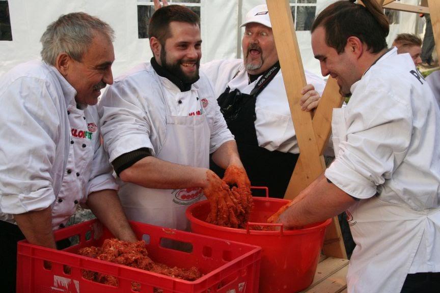 The men of Sevnica get to work making sausages like "Little Melania"