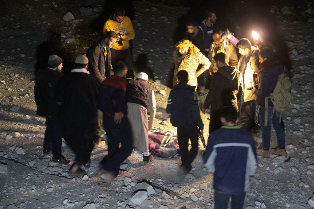 Syrian civil defence volunteers, known as the White Helmets, dig through the rubble following an air strike on a mosque in the rebel-held village of Al-Jina in Aleppo province late on March 16, 2017