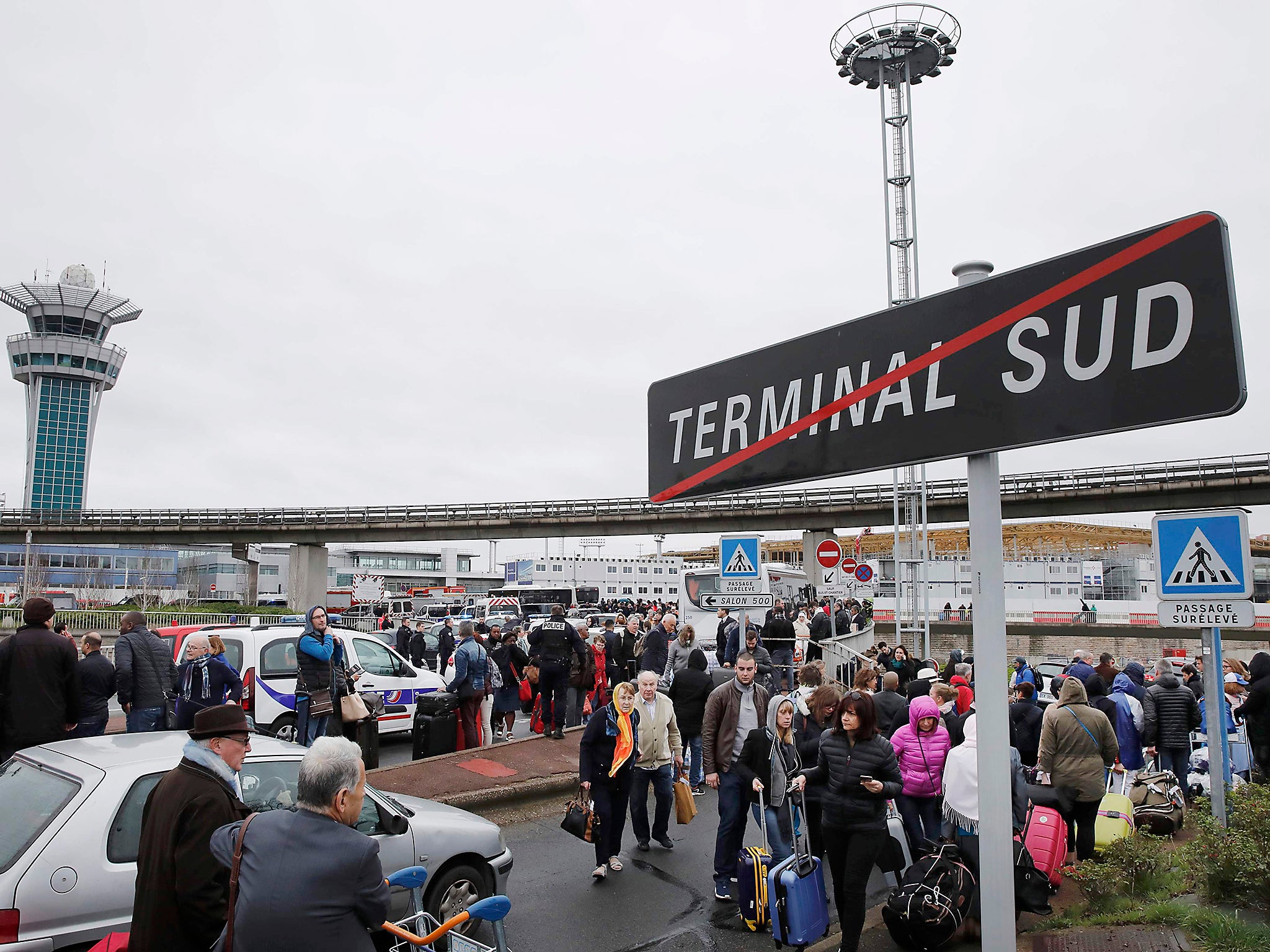 Passengers wait at Orly airport southern terminal after a shooting incident near Paris, France