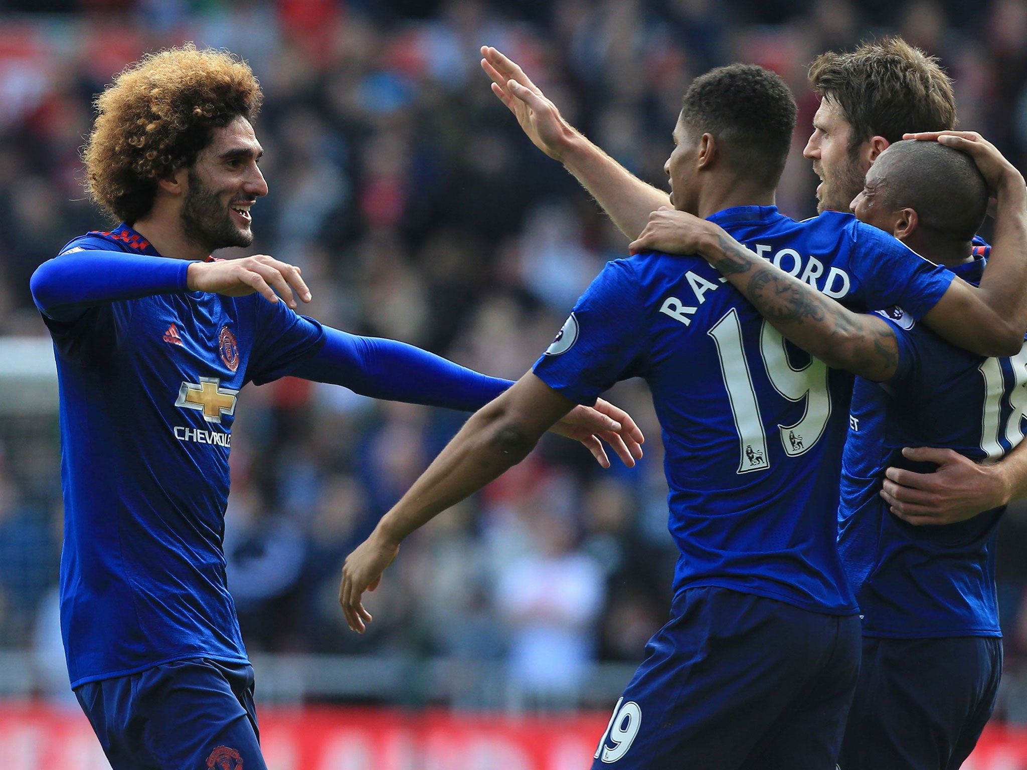 Fellaini celebrates with teammates after scoring the opening goal