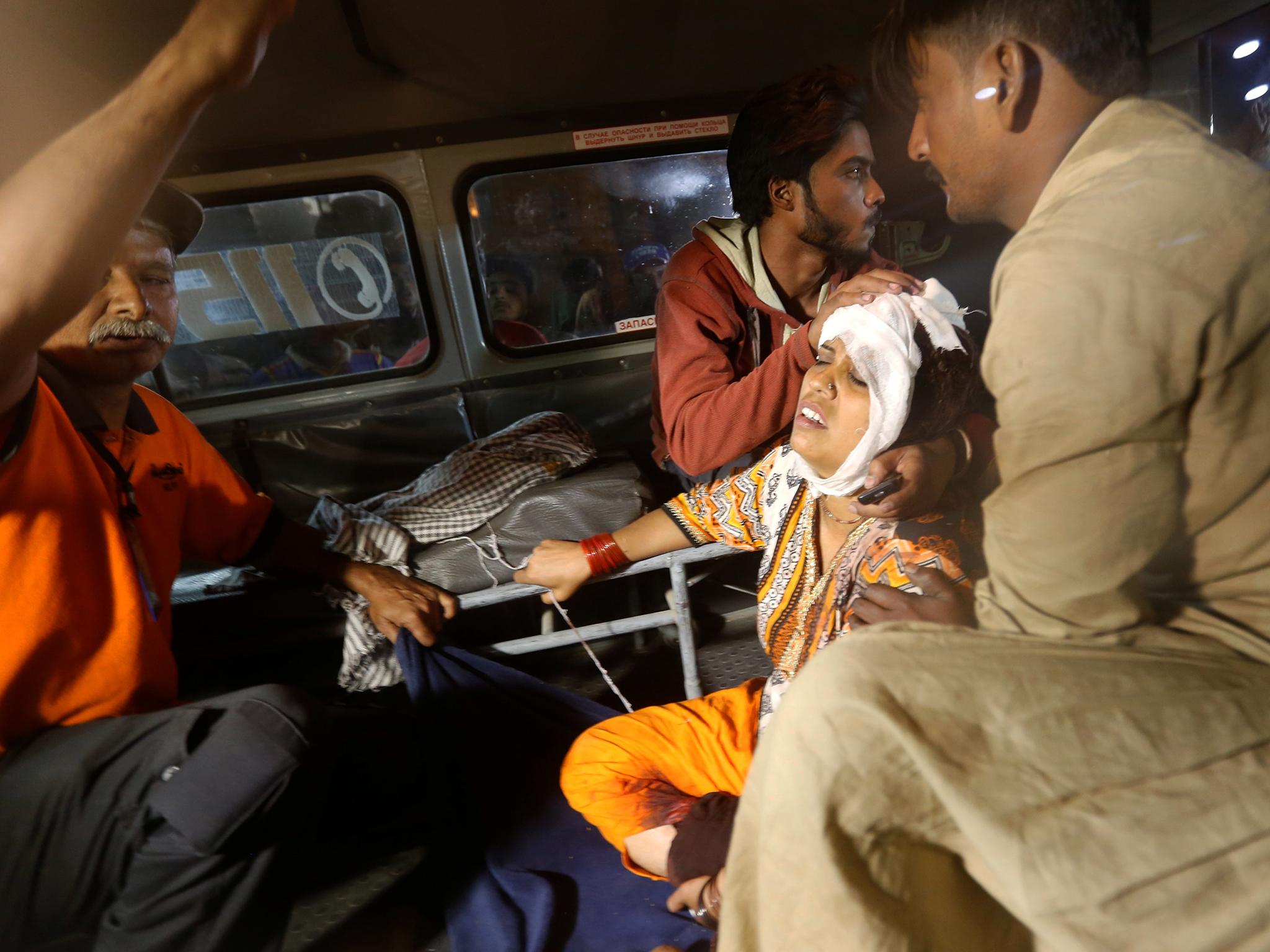 A woman arrives at a hospital in Karachi after an explosion at the Shah Noorani shrine in Balochistan (Akhtar Soomro/Reuters)