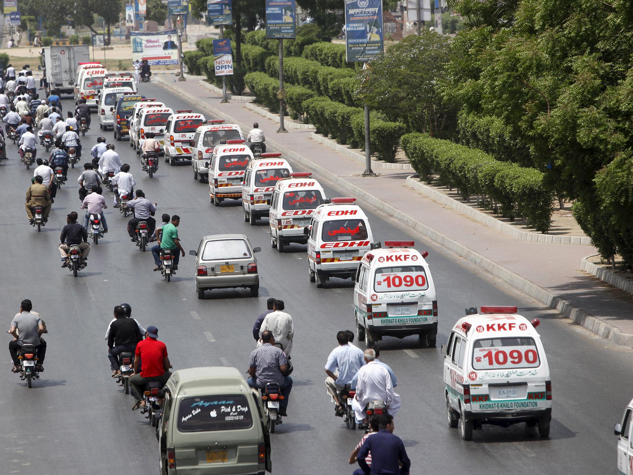 The foundation’s ambulances transfer bodies to a graveyard (Akhtar Soomro/Reuters)