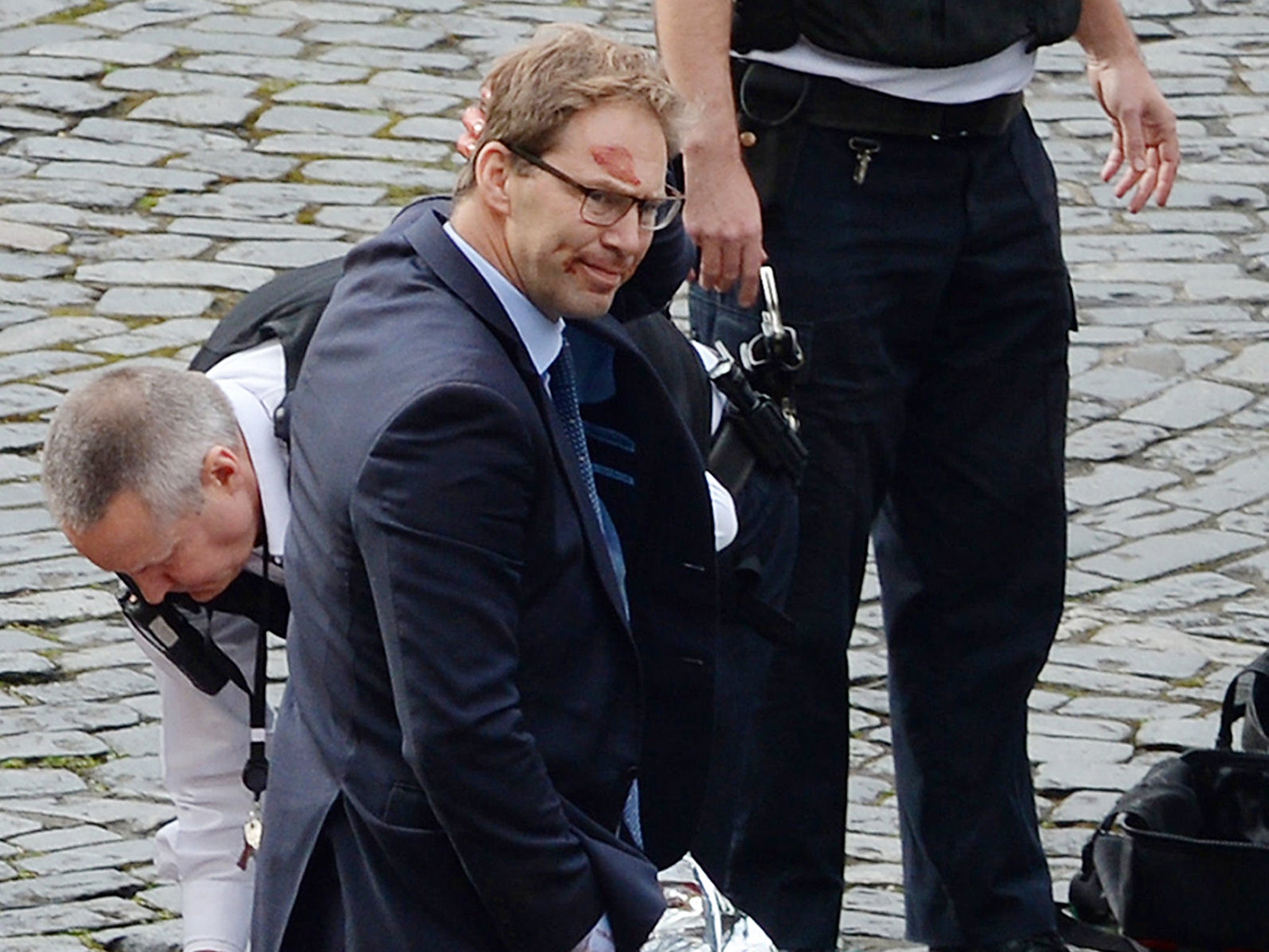 Conservative MP Tobias Ellwood stands amongst the emergency services at the scene outside the Palace of Westminster, London, after policeman has been stabbed and his apparent attacker shot by officers in a major security incident at the Houses of Parliament