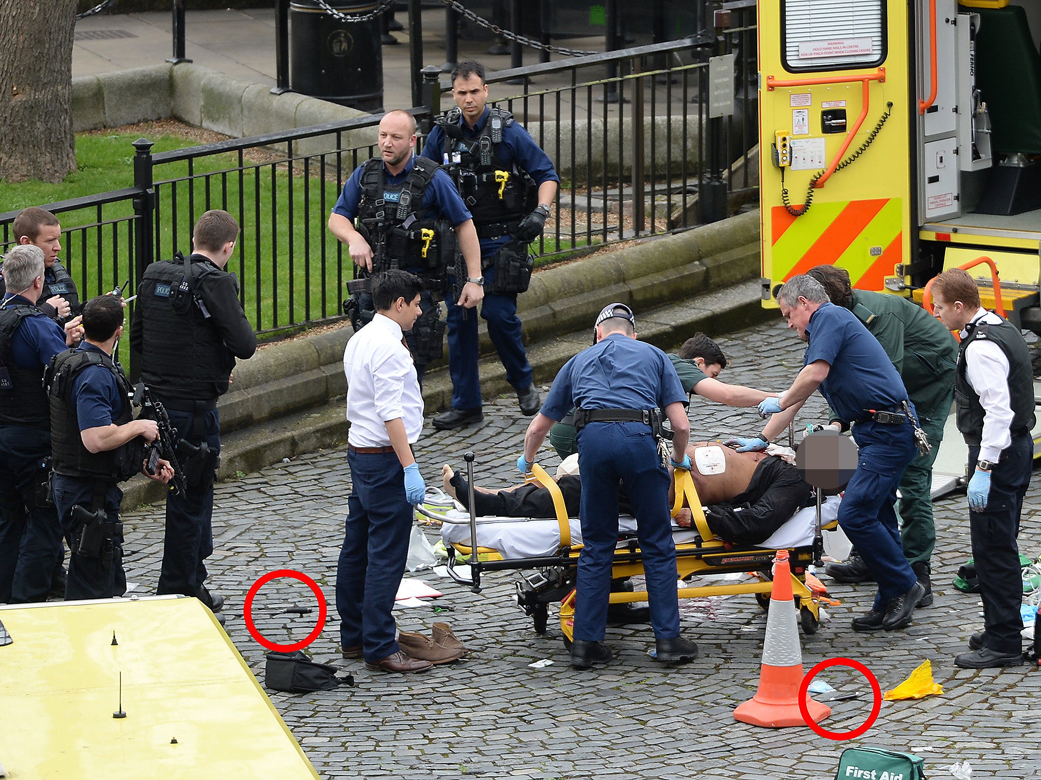 Emergency services at the scene while two knives lay on the floor outside the Palace of Westminster, London, after a policeman was stabbed and his apparent attacker shot by officers in a major security incident at the Houses of Parliament.