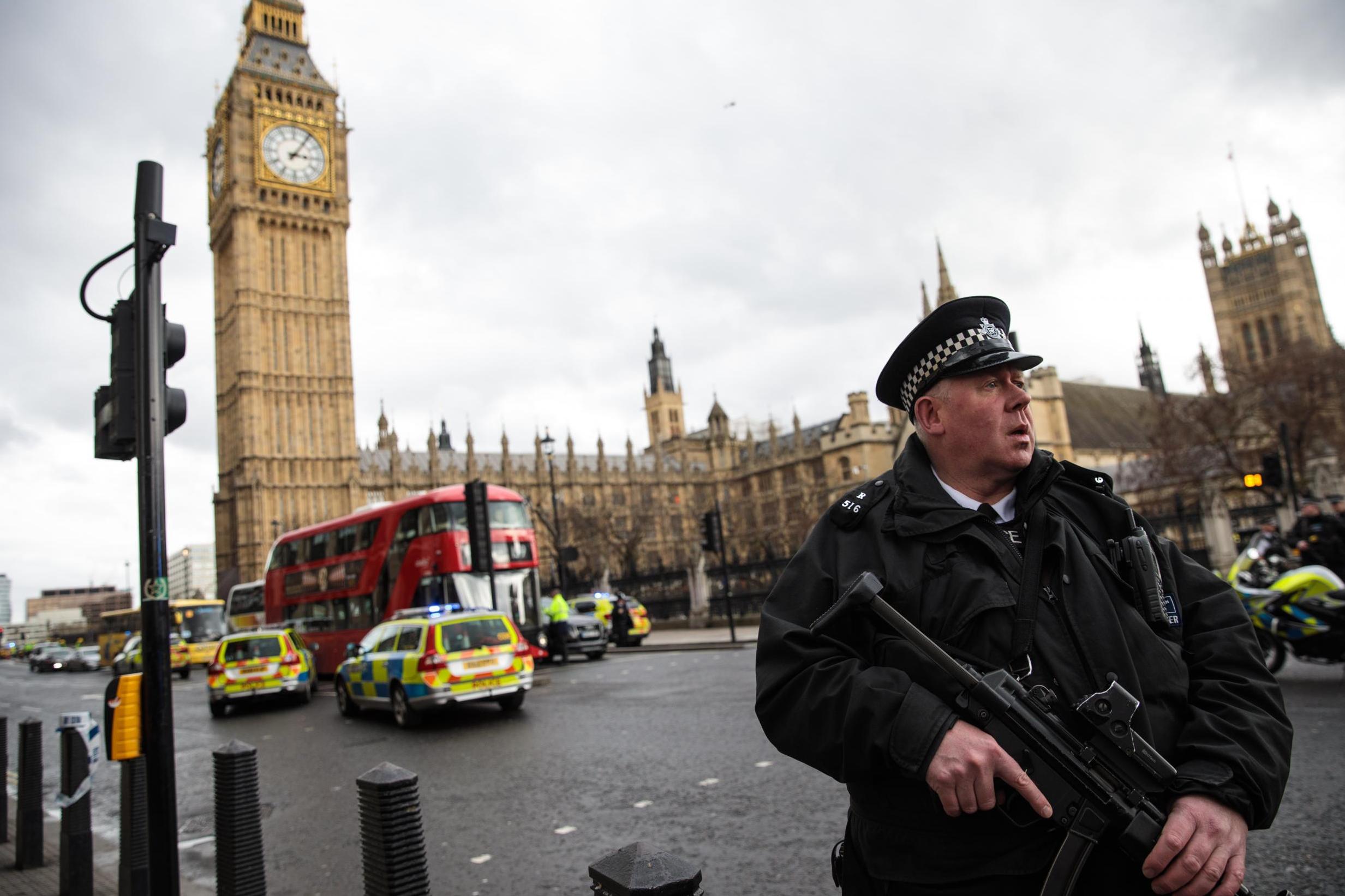 An armed police officer stands guard near Westminster Bridge and the Houses of Parliament (Jack Taylor /Getty)