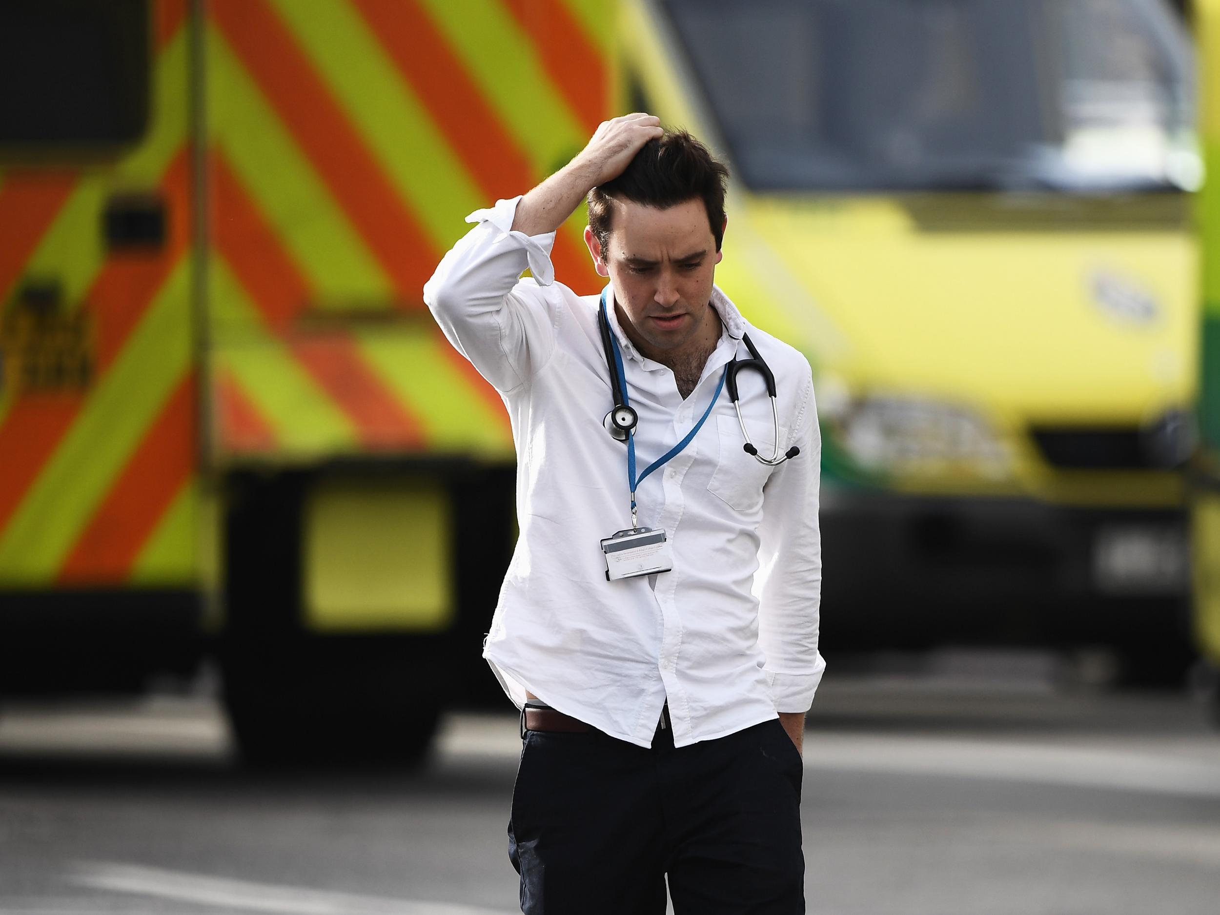 A medic near Westminster Bridge and the Houses of Parliament, where a police officer was stabbed yesterday