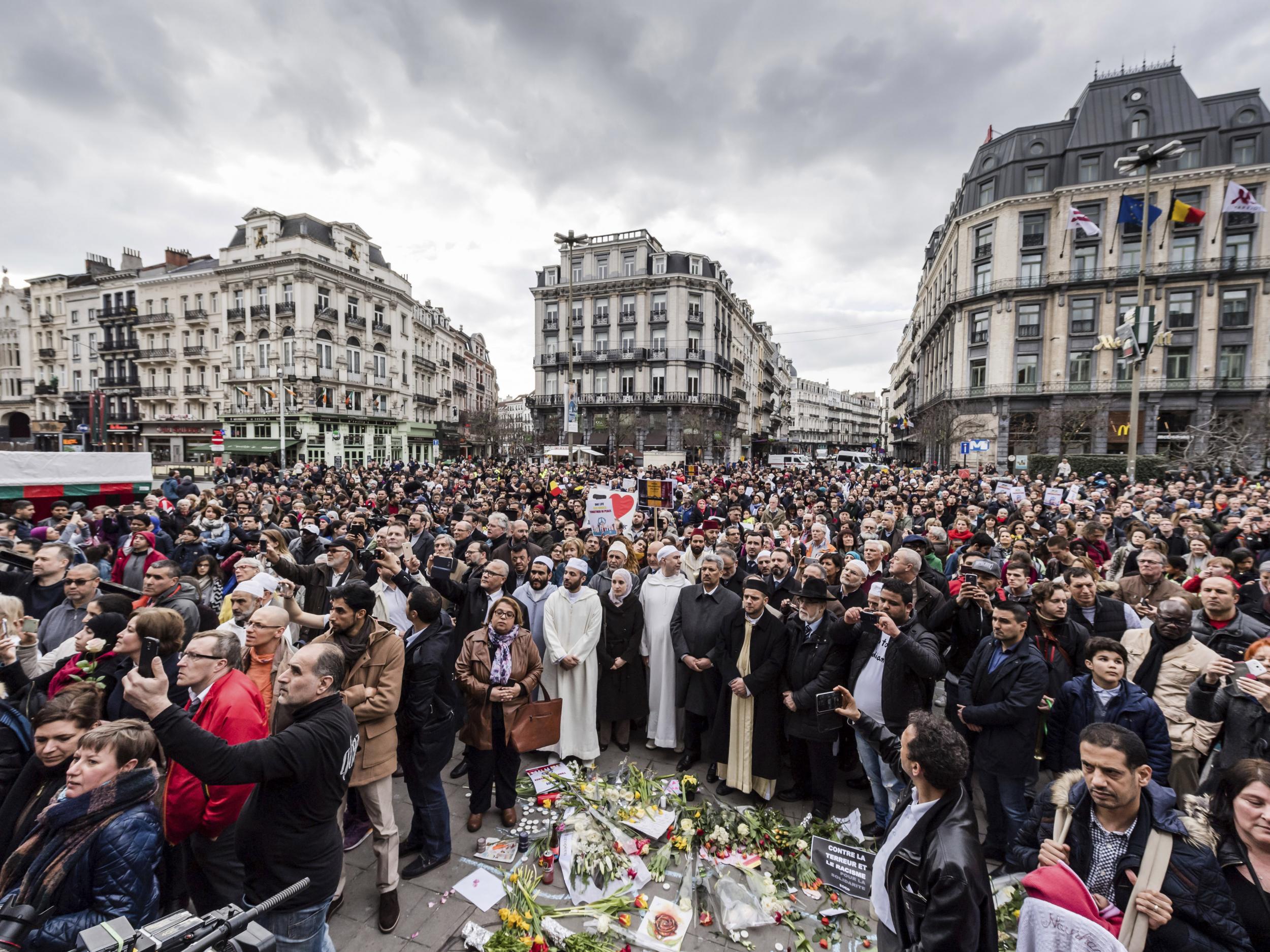 People stand for a moment of silence in Brussels