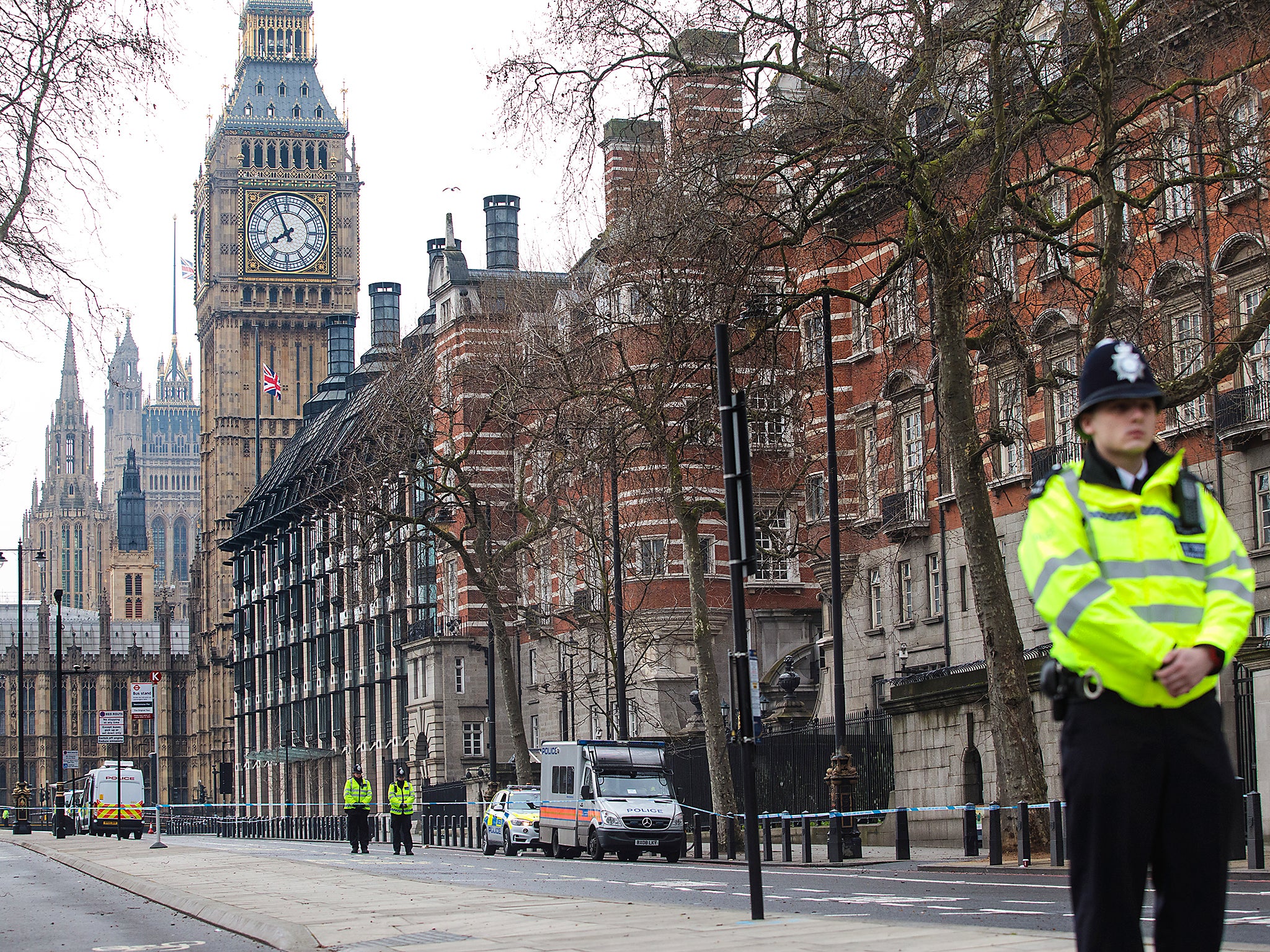 Police officers stand guard on Victoria Embankment following yesterday's attack in London, England