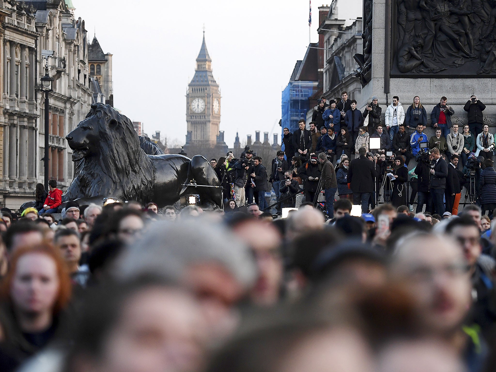 People gather during a candlelit vigil at Trafalgar Square