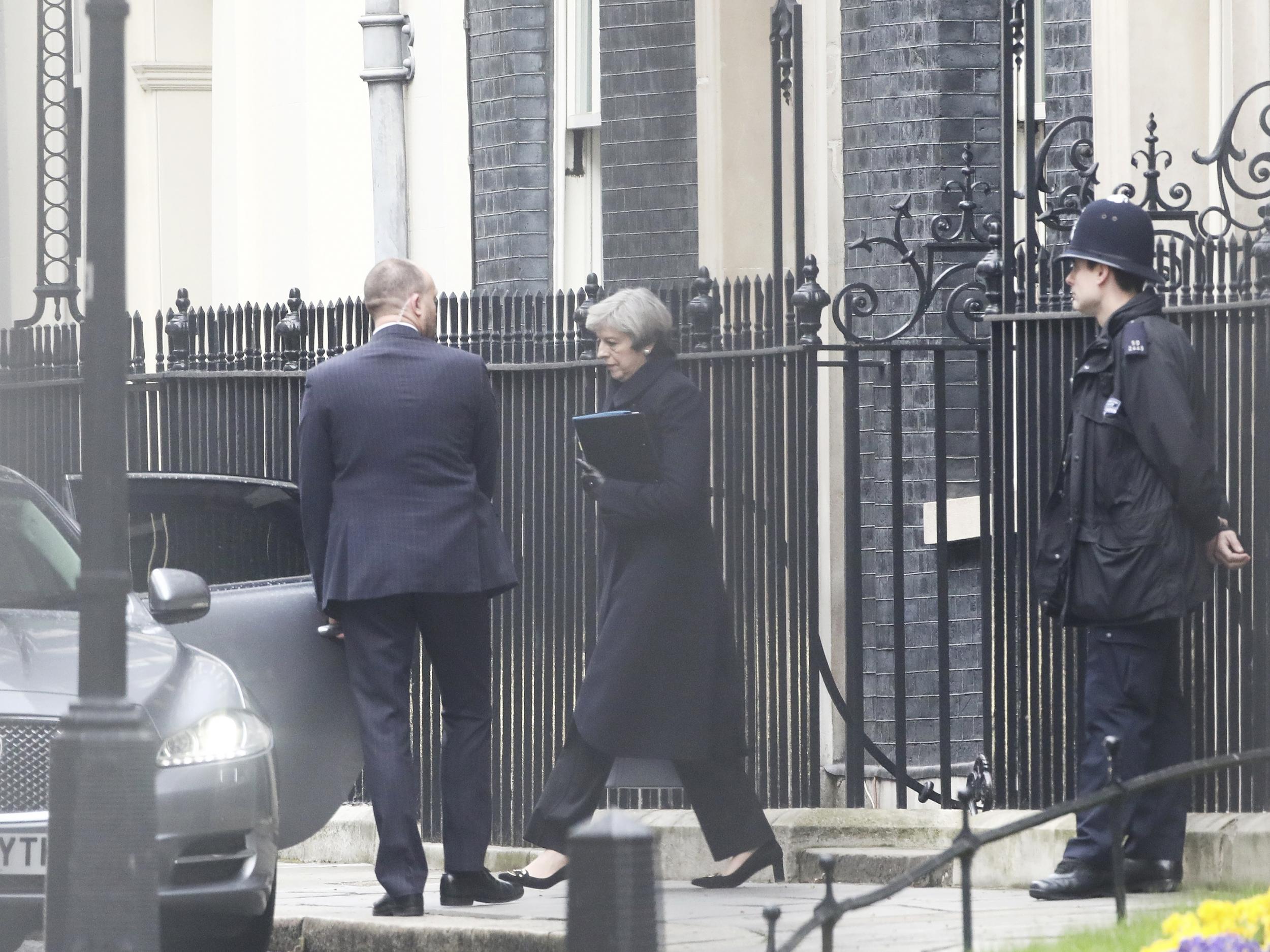 Prime Minister Theresa May leaves 10 Downing Street the morning after an attack by a man driving a car and wielding a knife left five people dead and dozens injured