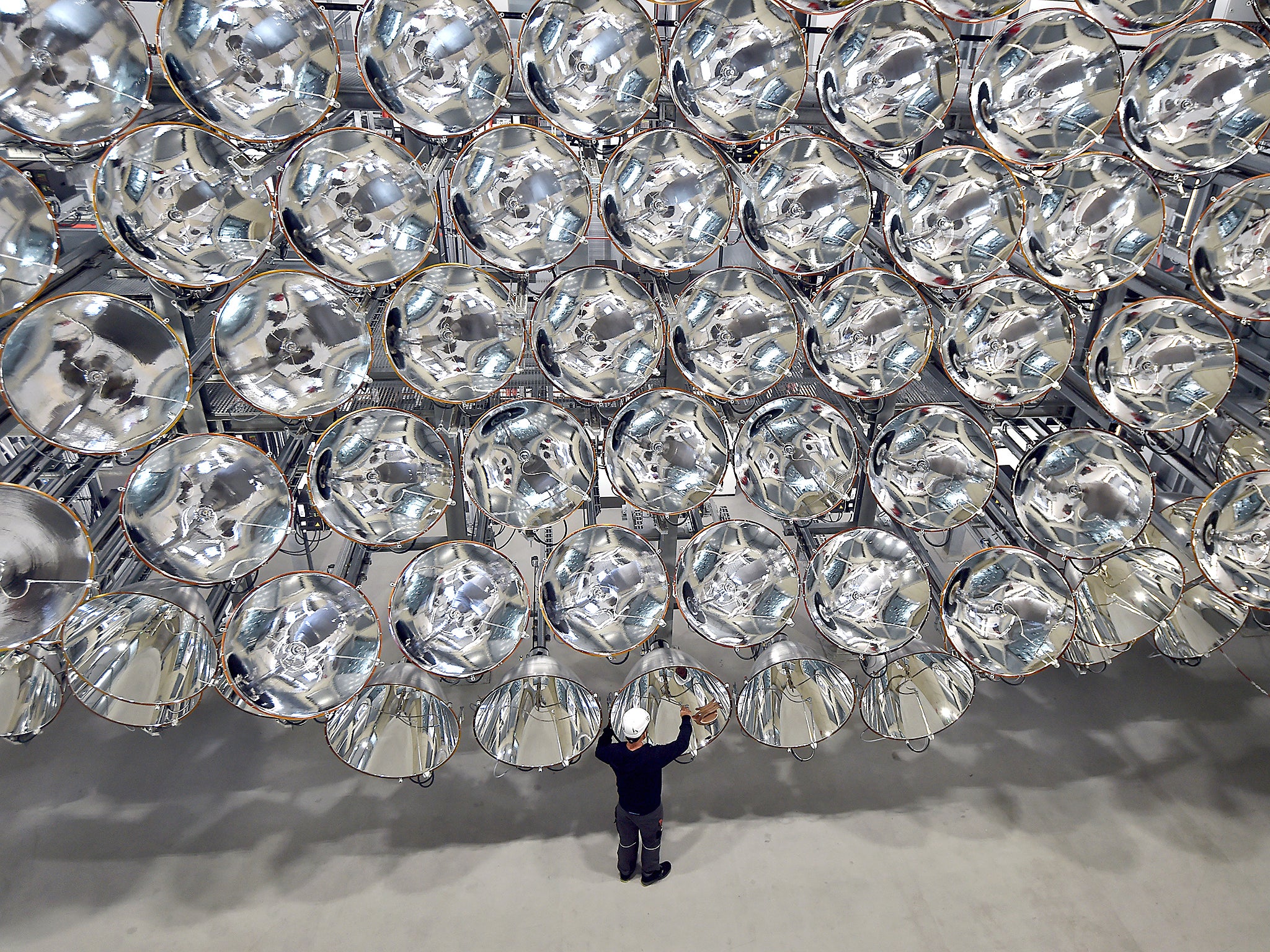 Photo engineer Volkmar Dohmen stands in front of xenon short-arc lamps in the DLR German national aeronautics and space research center in Juelich, western Germany