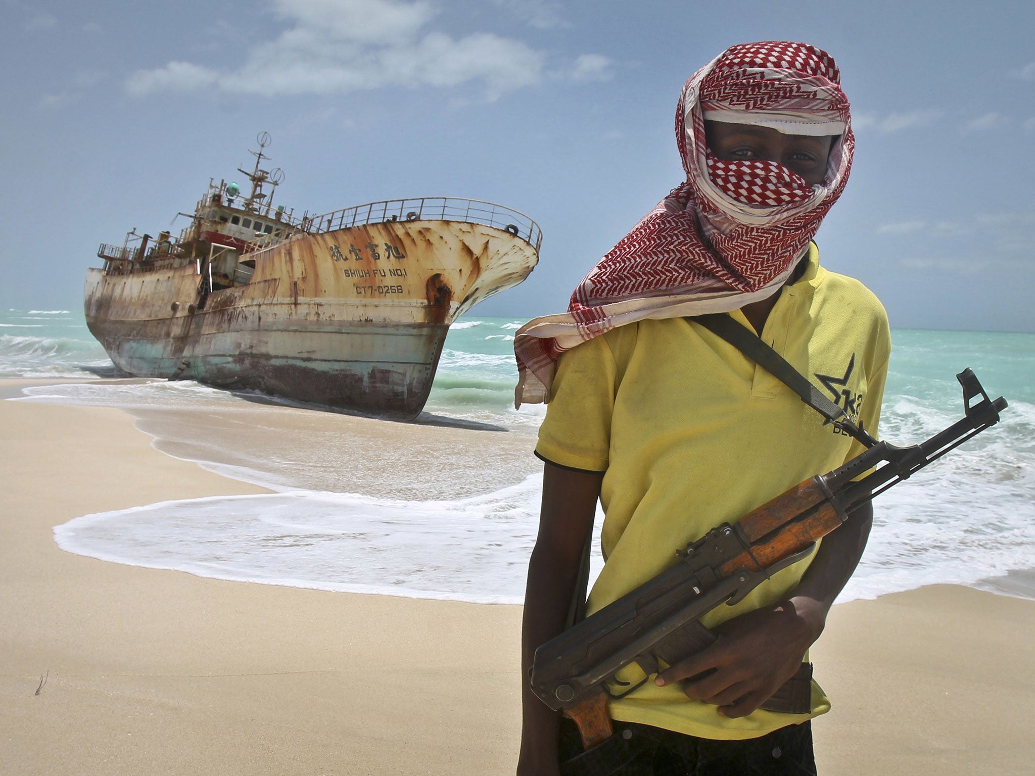 Somali pirates have conducted two hijackings this month, in the biggest spike of activity for almost five years. File image shows pirate Hassan standing next to a Taiwanese fishing vessel in the once-bustling pirate den of Hobyo, Somalia, September 2012