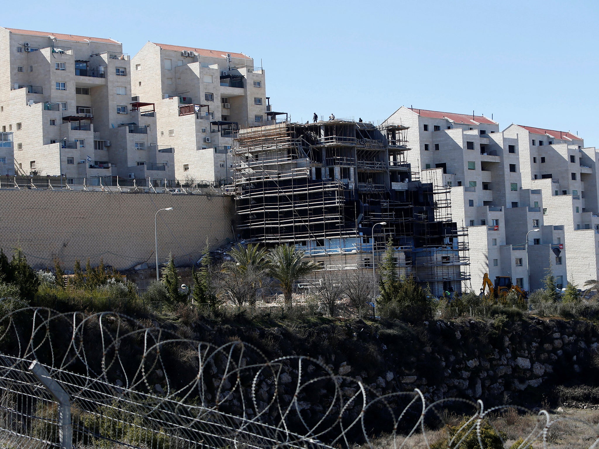 Labourers work at a construction site in the settlement of Kiryat Arba, near the West Bank city of Hebron