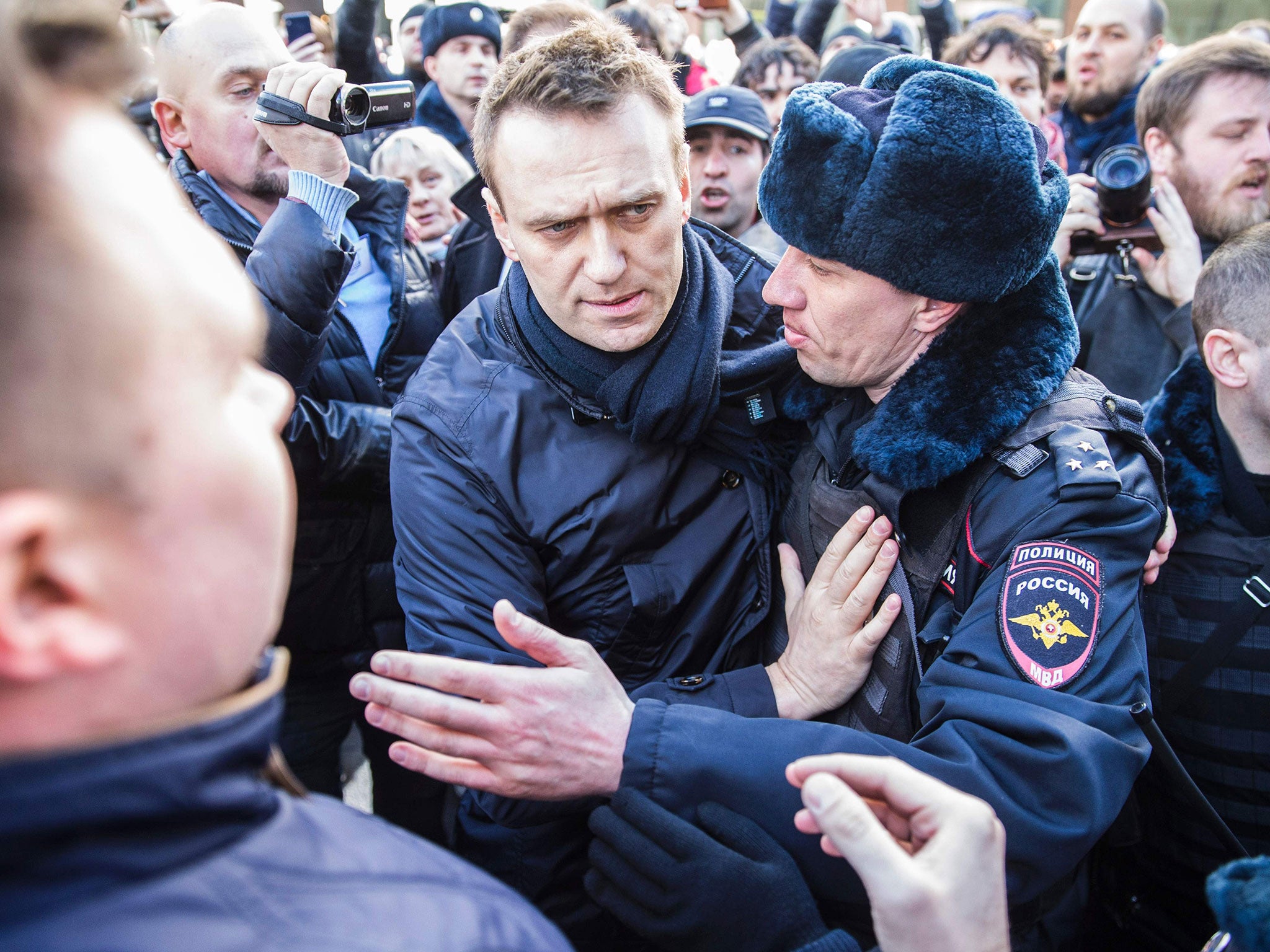 Police officers detaining Kremlin critic Alexei Navalny during an unauthorised anti-corruption rally in central Moscow (file image)