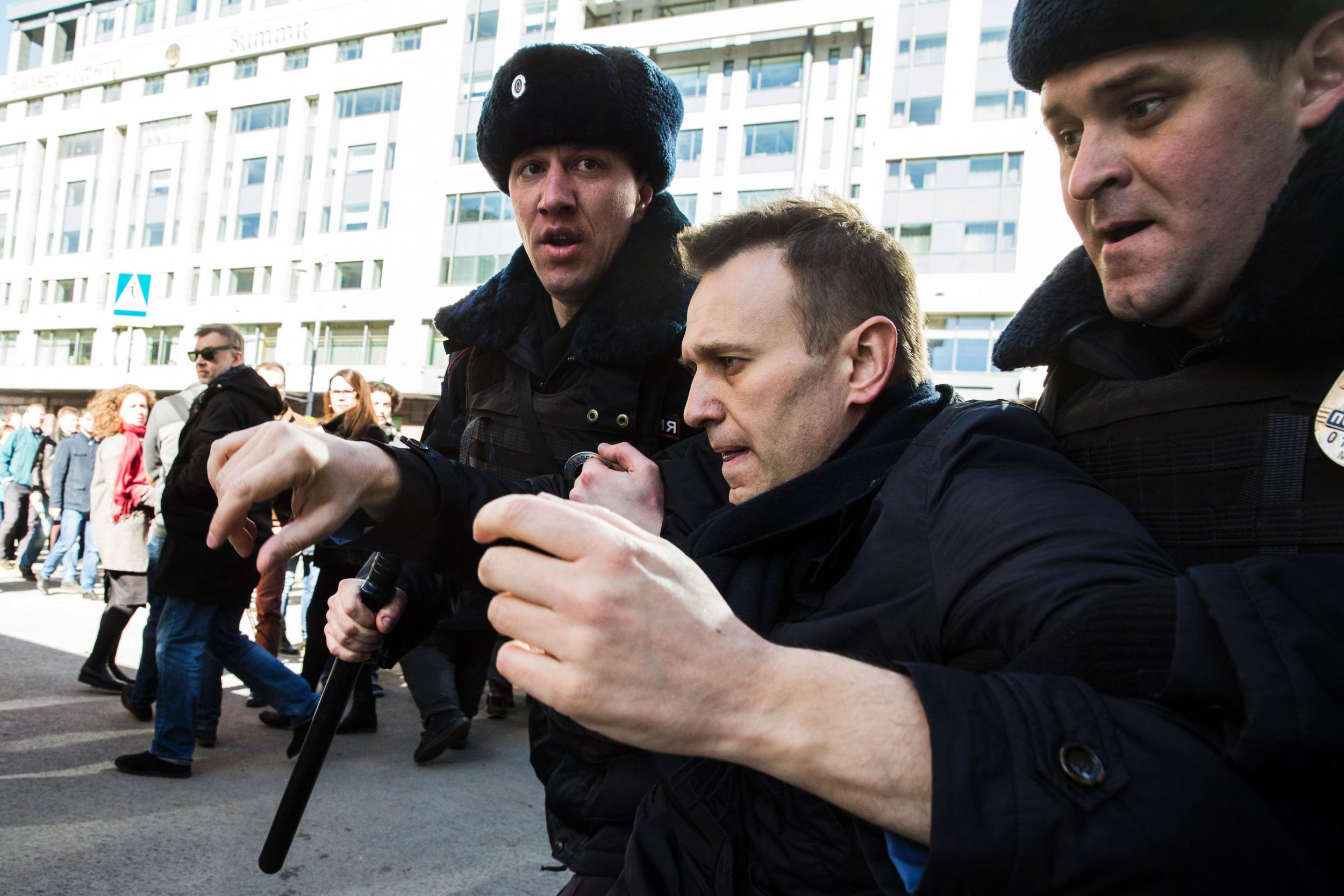 Police officers detain Kremlin critic Alexei Navalny during an unauthorised anti-corruption rally in central Moscow