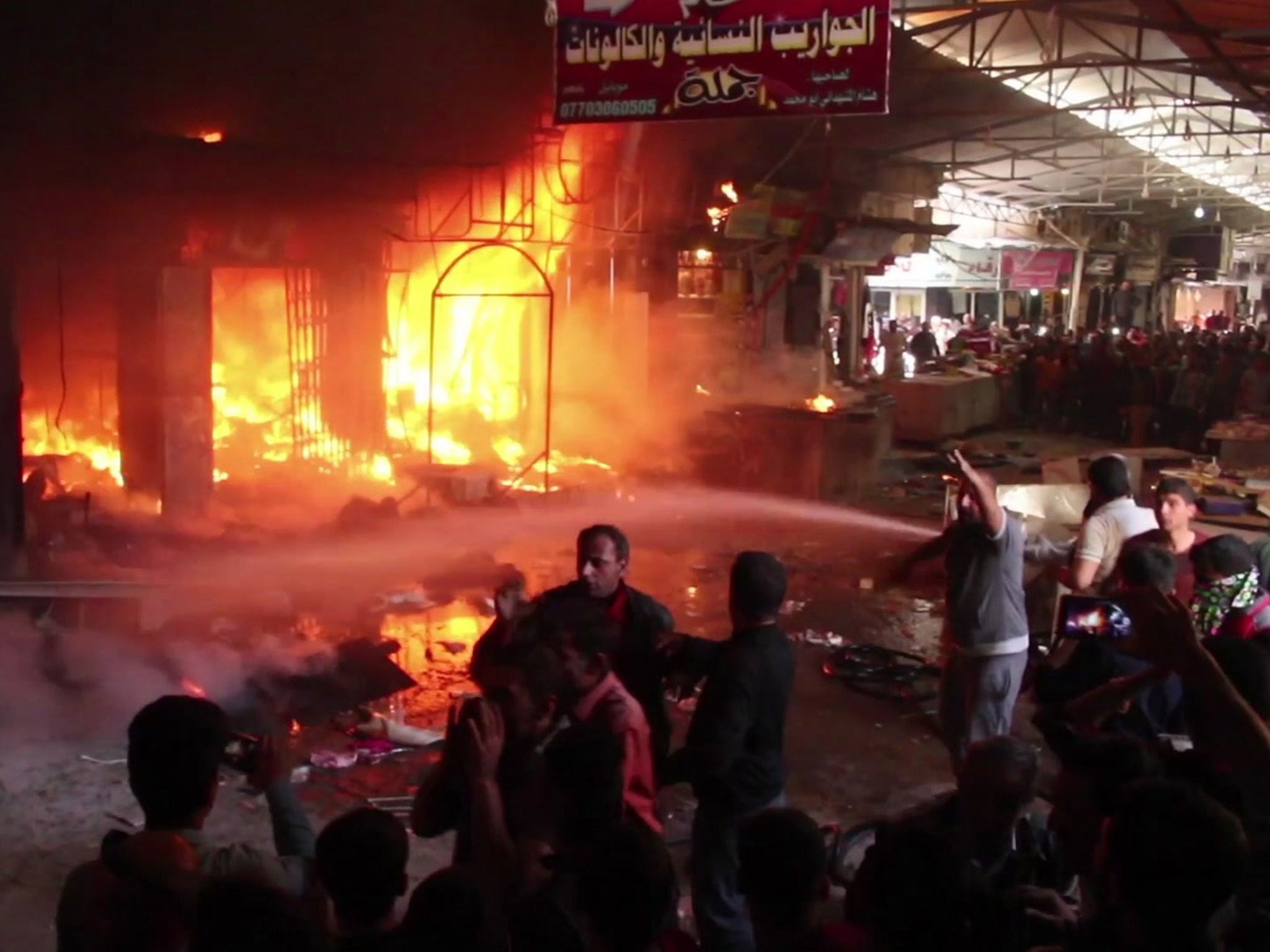 Still from a video shows multiple market stalls on fire during the blaze at Nabi Yunus market in east Mosul, Iraq, on Sunday, 26 March