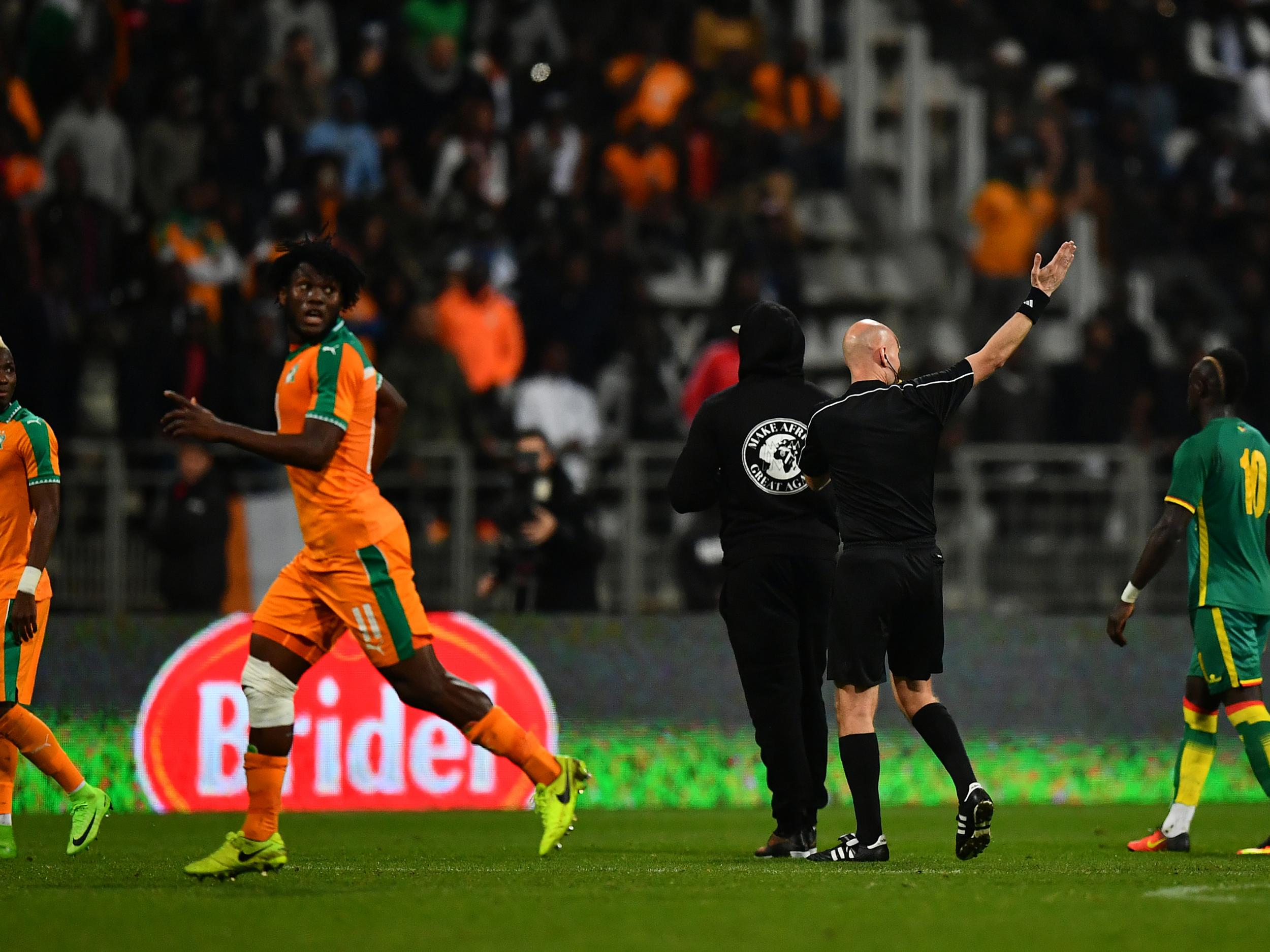 The players were forced to run away from several pitch invaders