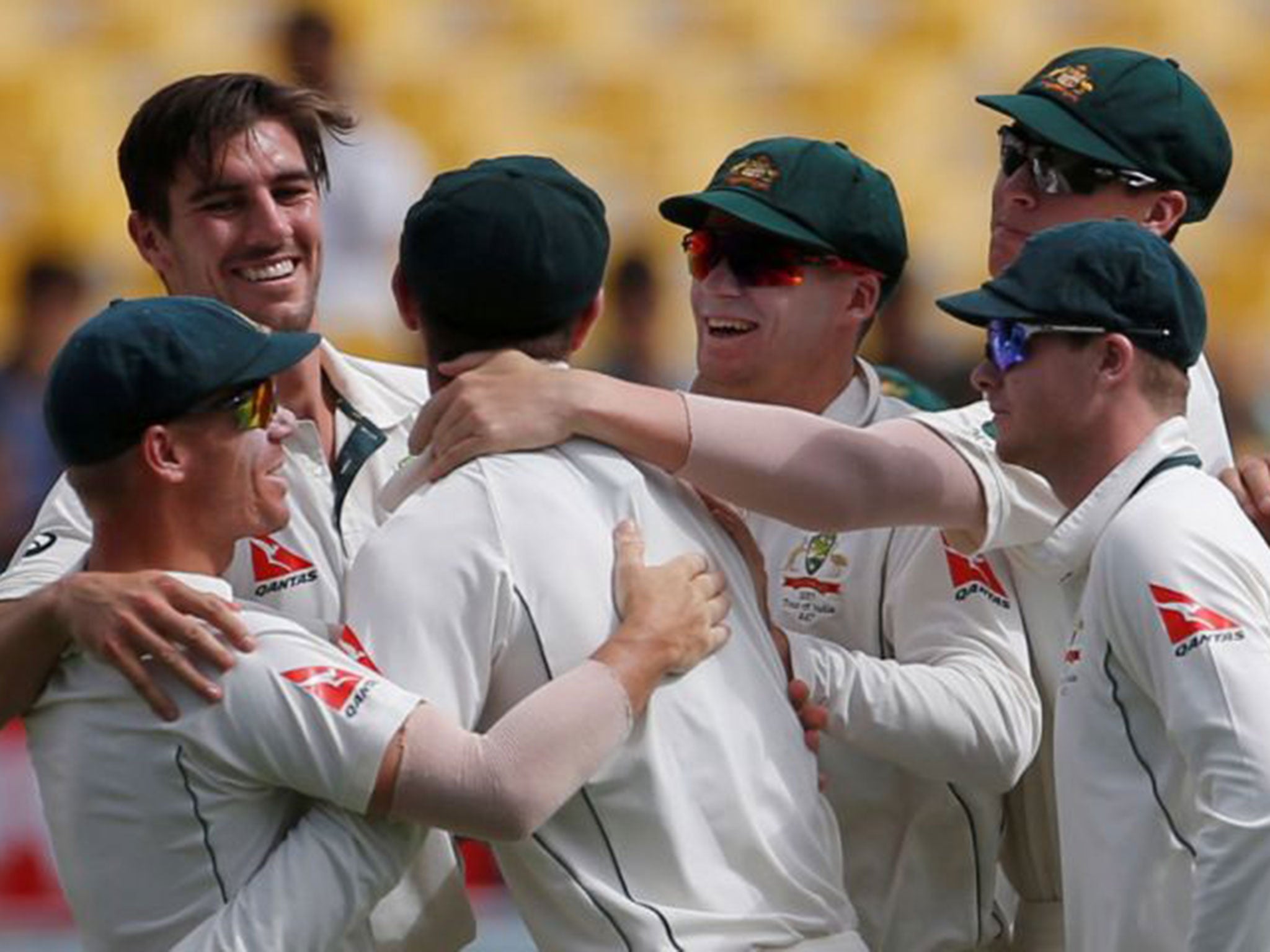 Australia players celebrate the dismissal of Chetesh Pujara