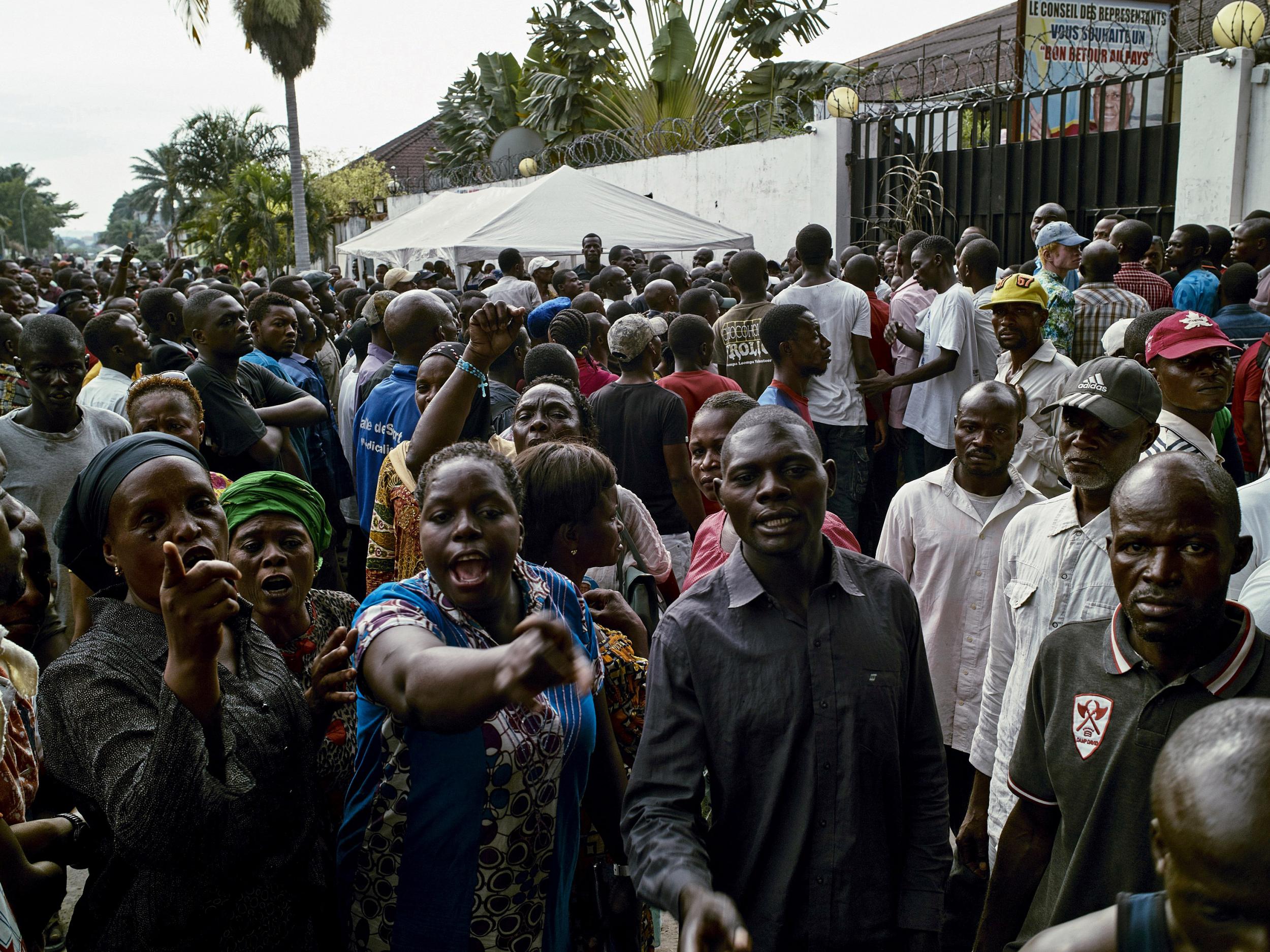 Supporters of the Congolese main opposition part Union for Democracy and Social Progress (UDPS) shout slogans as they gather outside the residence of the late veteran opposition leader Etienne Tshisekedi in the Limete Municipality in Kinshasa