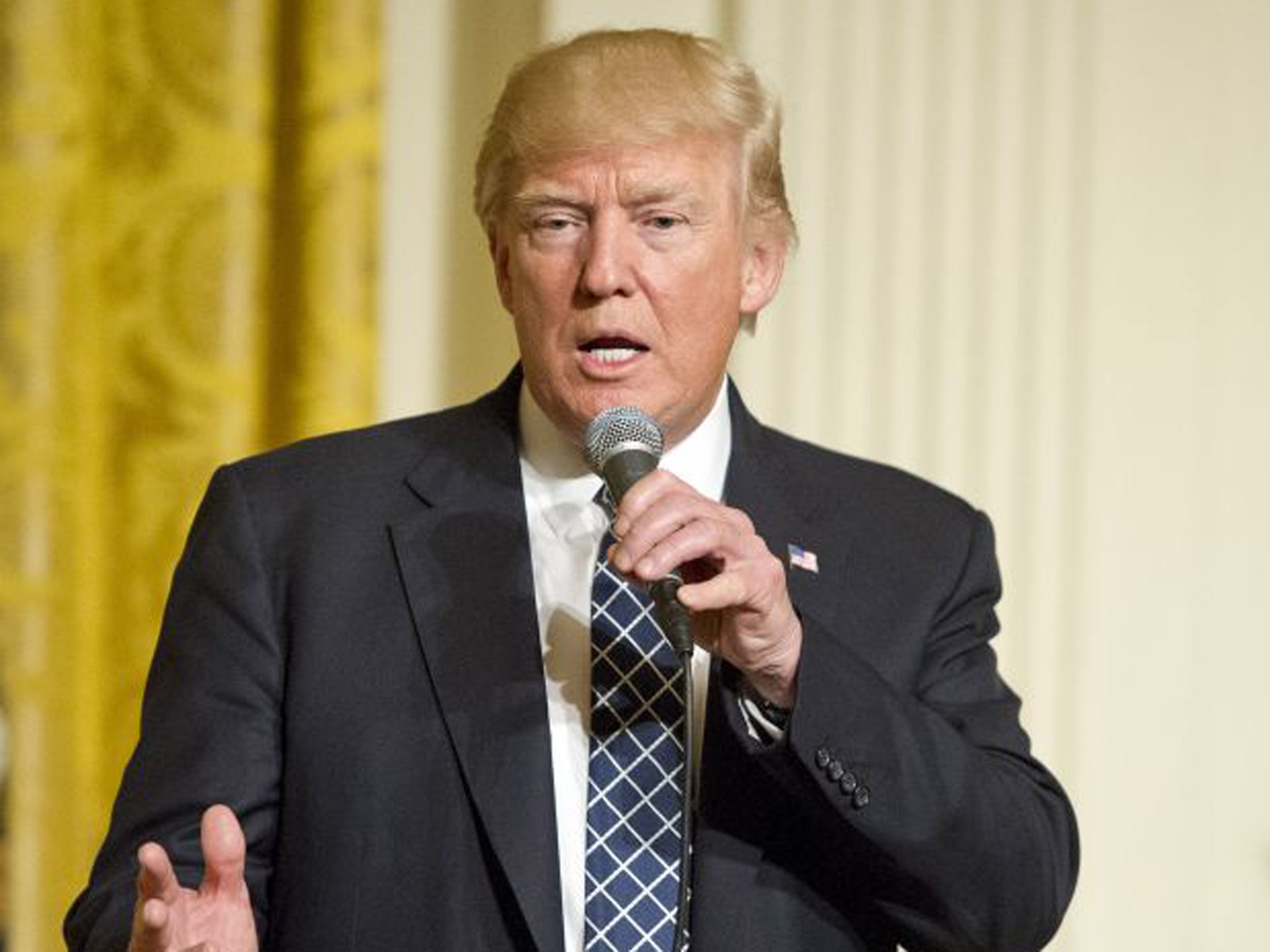 President Donald Trump makes remarks at a reception for U.S. Senators and their spouses in the East Room of the White House