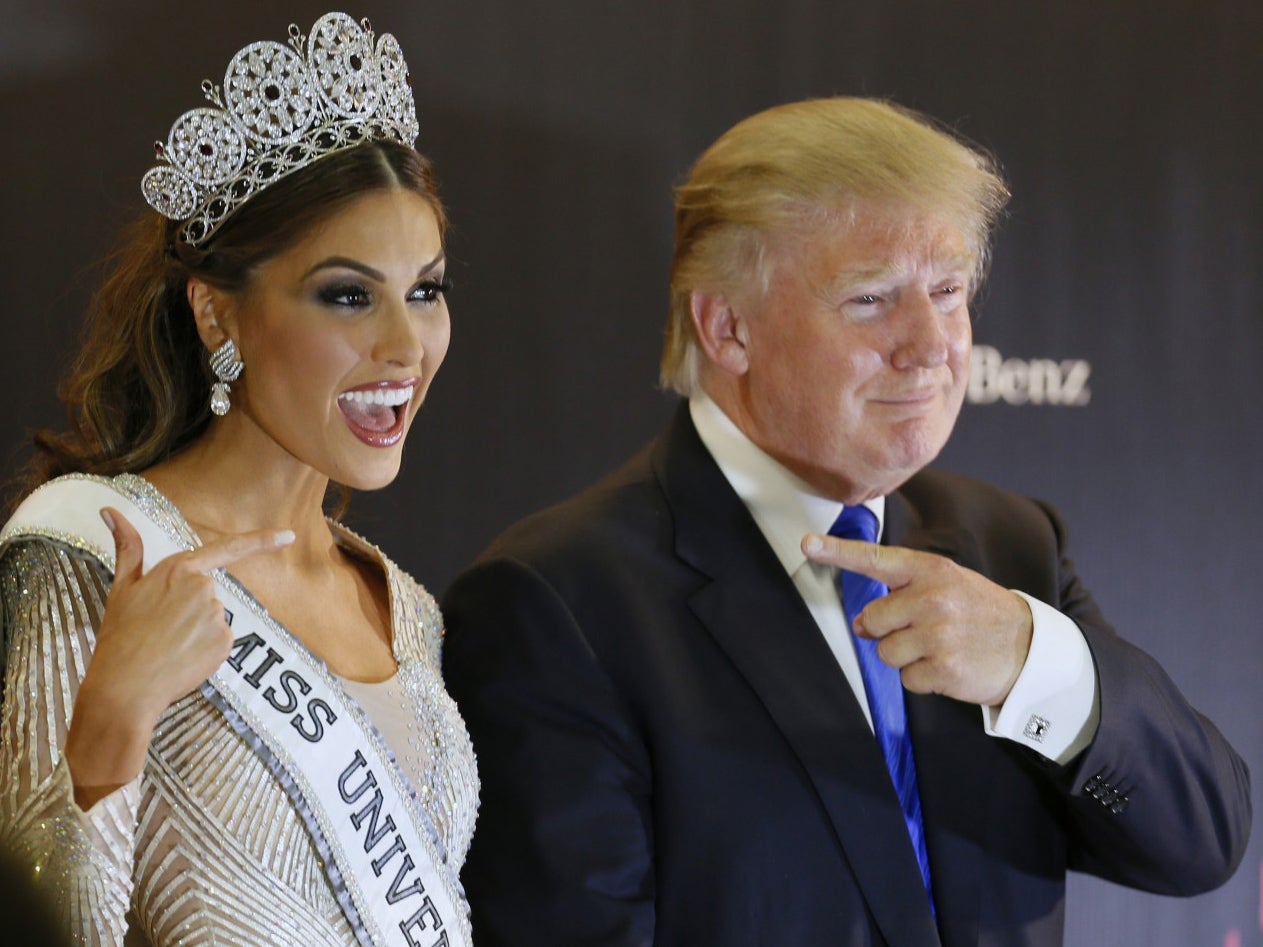 Miss Universe 2013, Gabriela Isler of Venezuela, left, and pageant owner Donald Trump point to each other while posing for a photo after the 2013 Miss Universe pageant in Moscow on November 9 2013