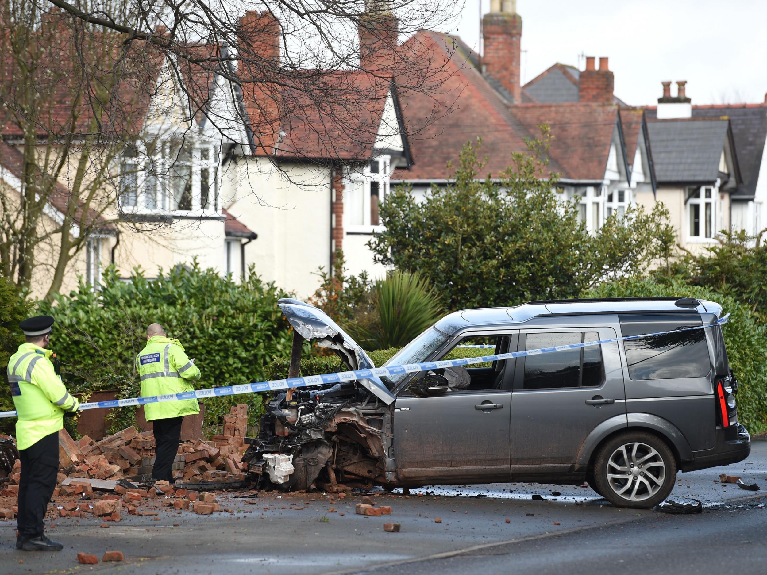 Police inspect a Land Rover stolen from the scene near to where a 13-year-old boy and his mother died after being stabbed at their home in Greyhound Lane, Stourbridge