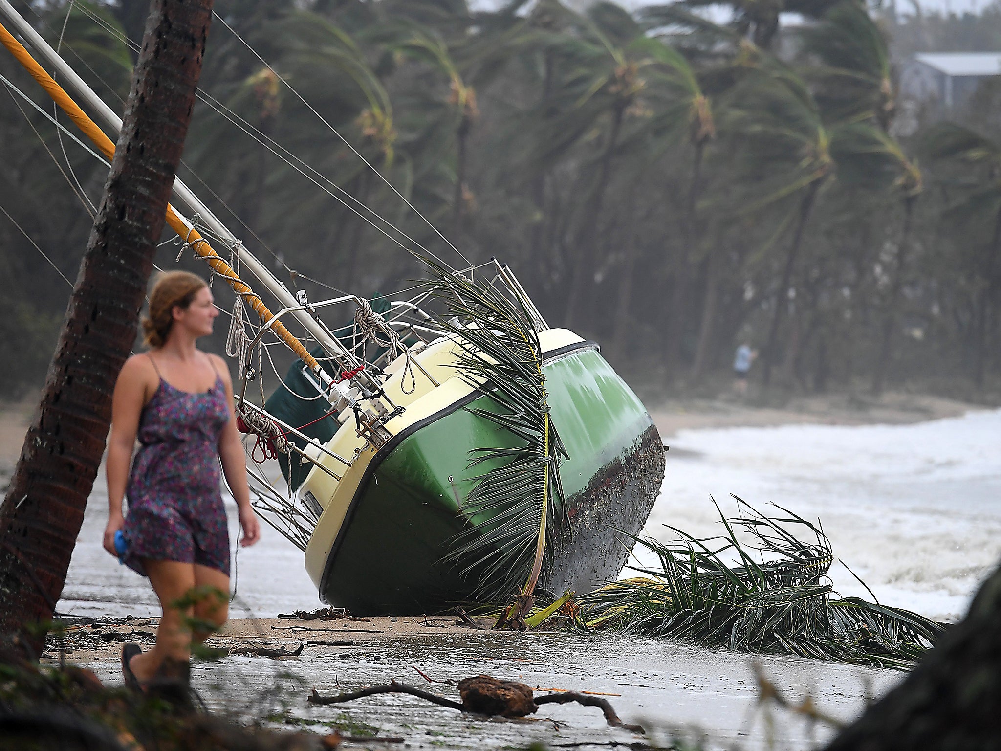 A boat is washed ashore at Airlie Beach, Queensland, Australia