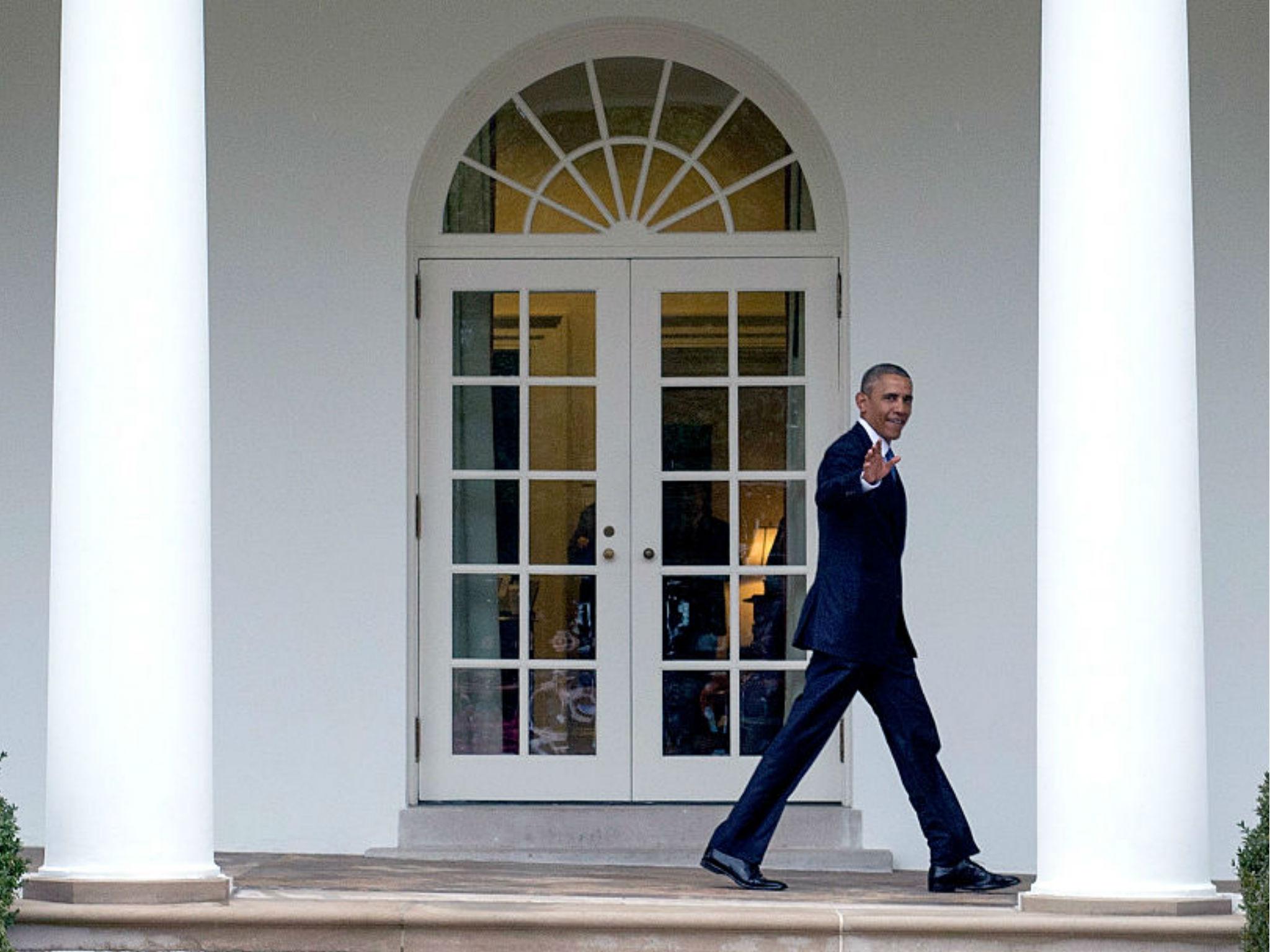 Barack Obama walks on the colonnade after leaving the Oval Office for the last time as President, in Washington, DC on January 20, 2017