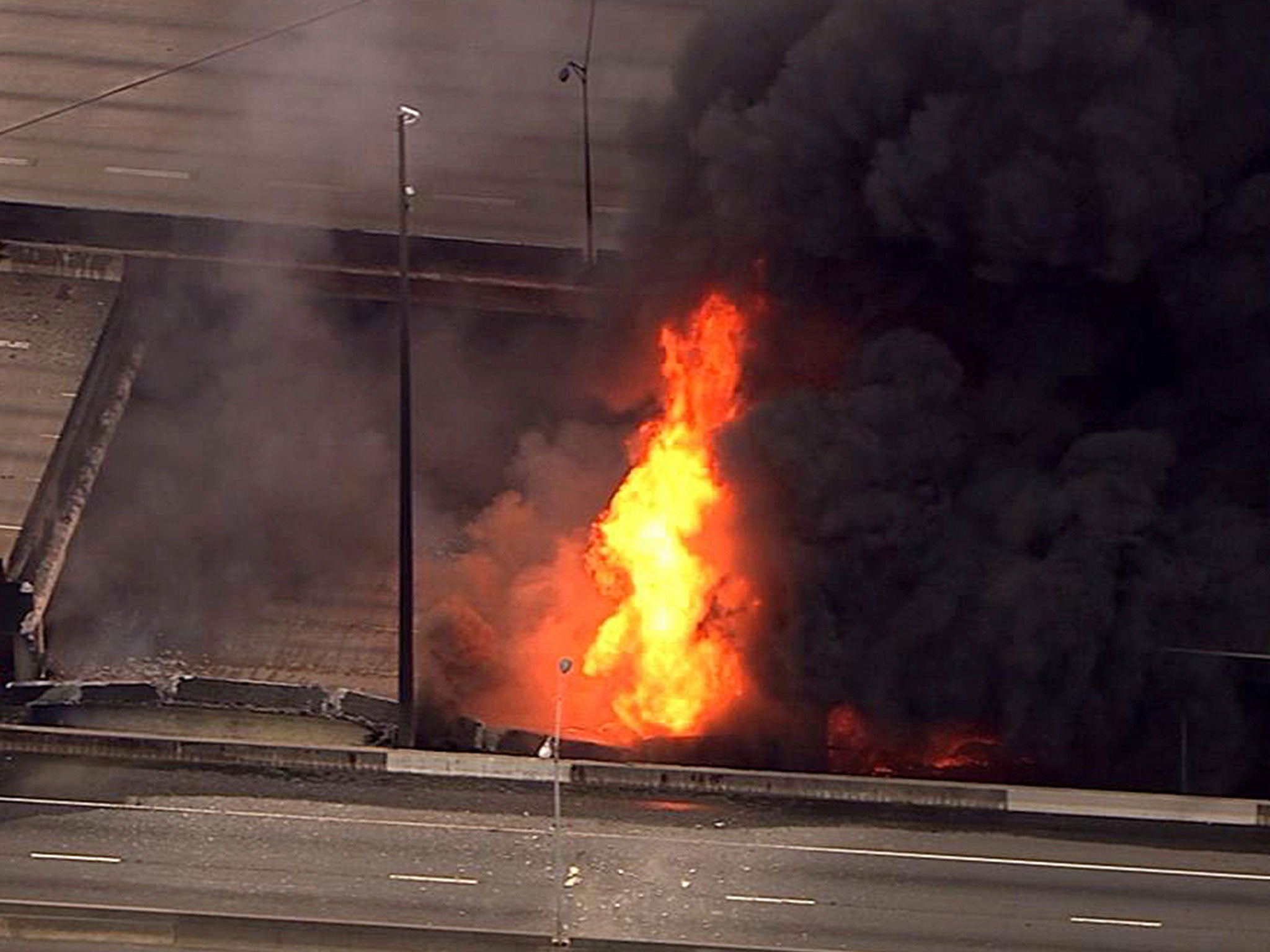 An aerial image from a video provided by WSB-TV showing a large fire that caused an overpass on Interstate 85 to collapse