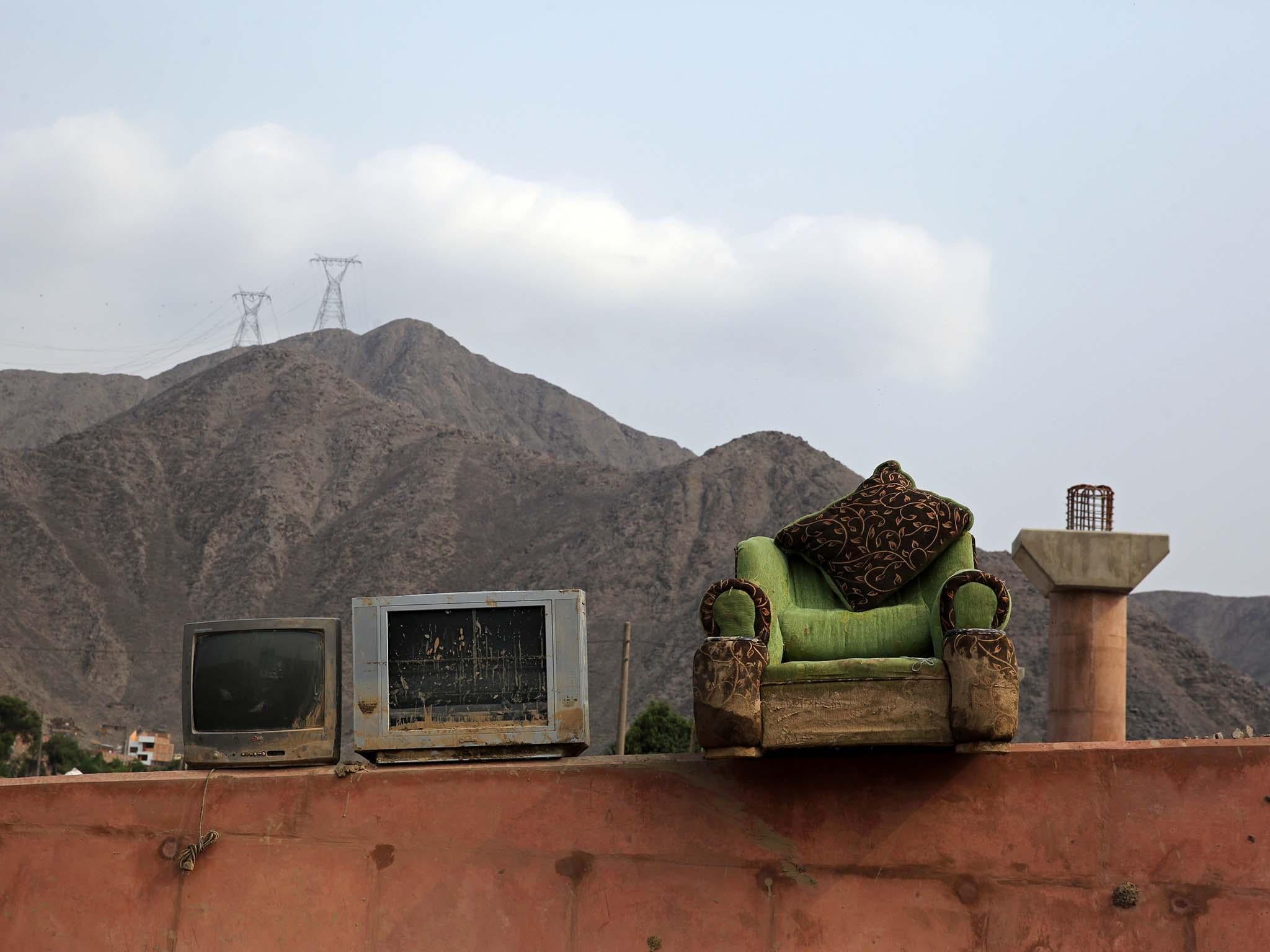 Home items on a pedestrian bridge after rivers breached their banks due to torrential rains in Carapongo Huachipa, Lima, 10 days ago