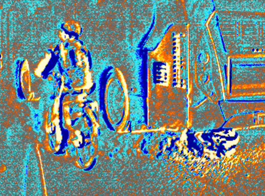 An enhanced view of exhaust fumes from a bus shows them swirling around a cyclist