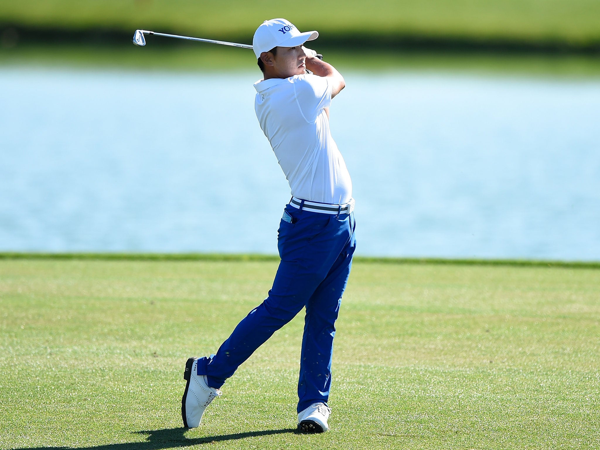 Kang plays his second shot from the fairway on the 18th hole during the first round