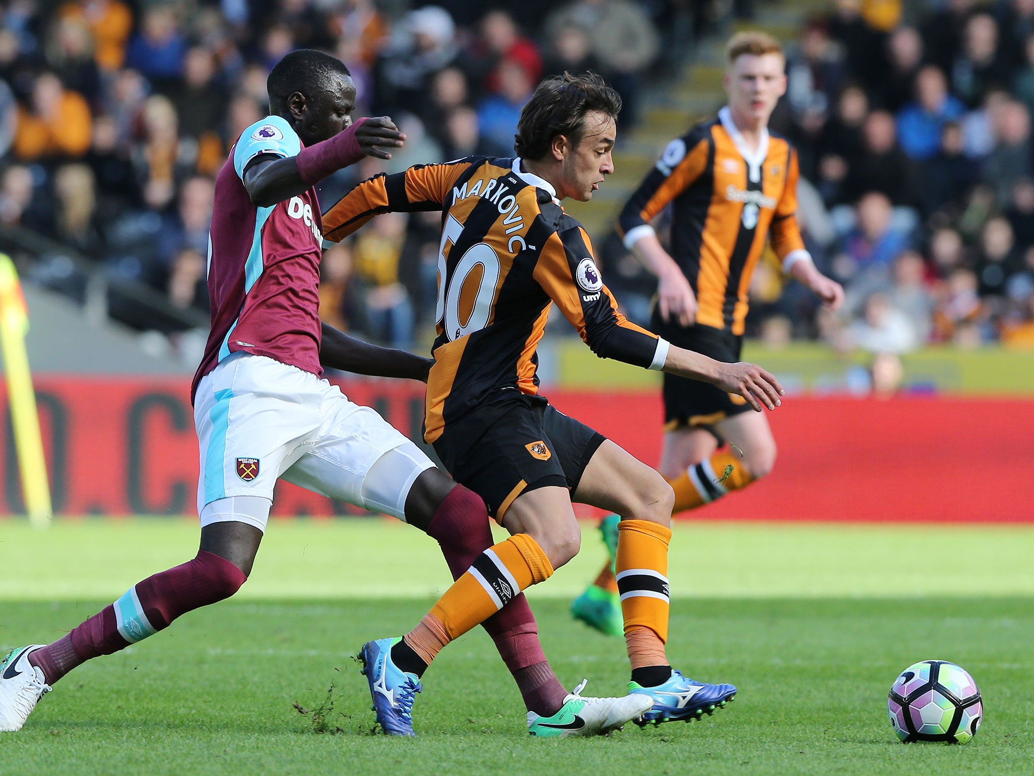 Cheikhou Kouyate (L) attempts to tackle Lazar Markovic