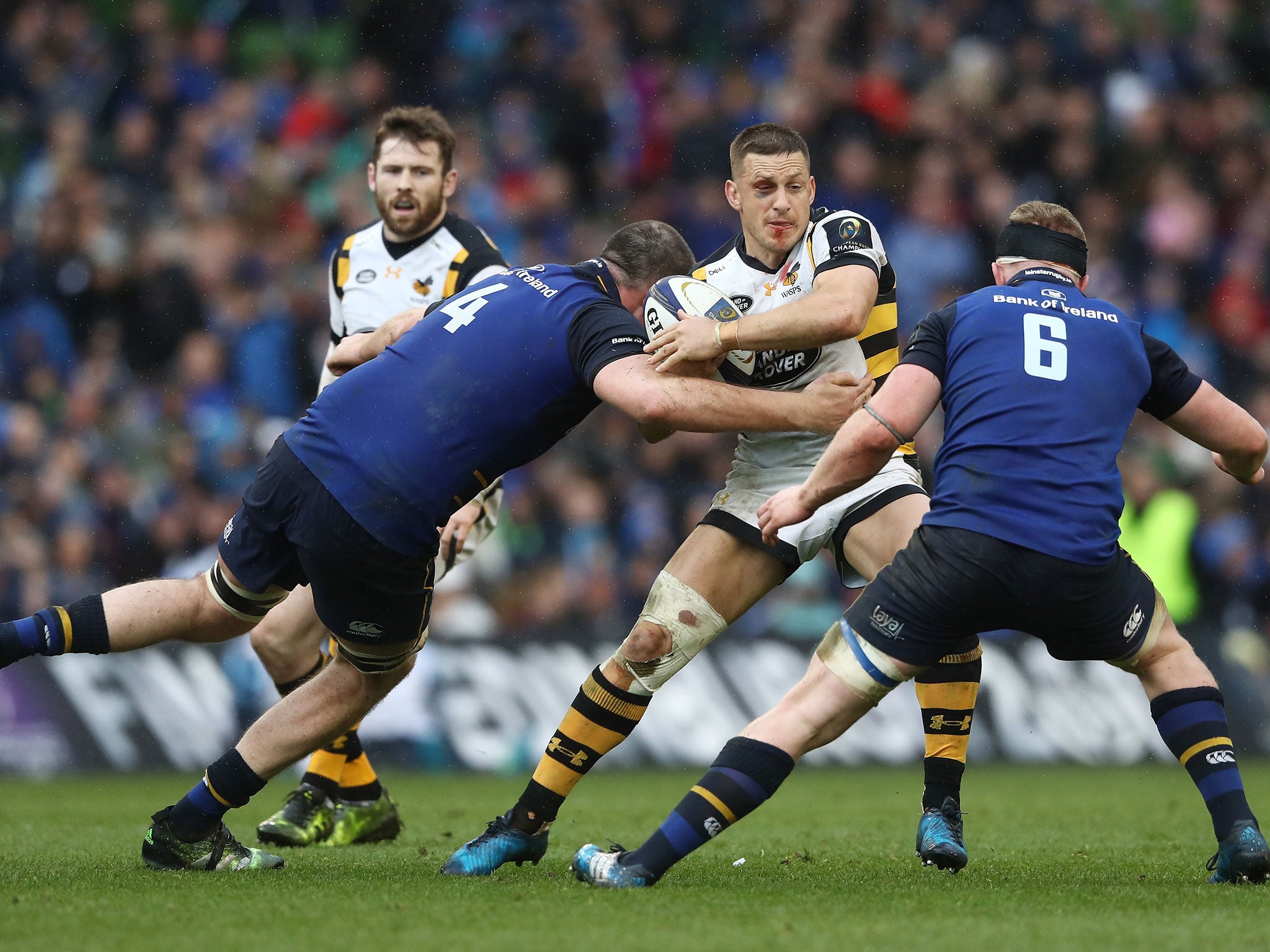 Jimmy Gopperth of Wasps is tackled by Devin Toner and Dan Leavy