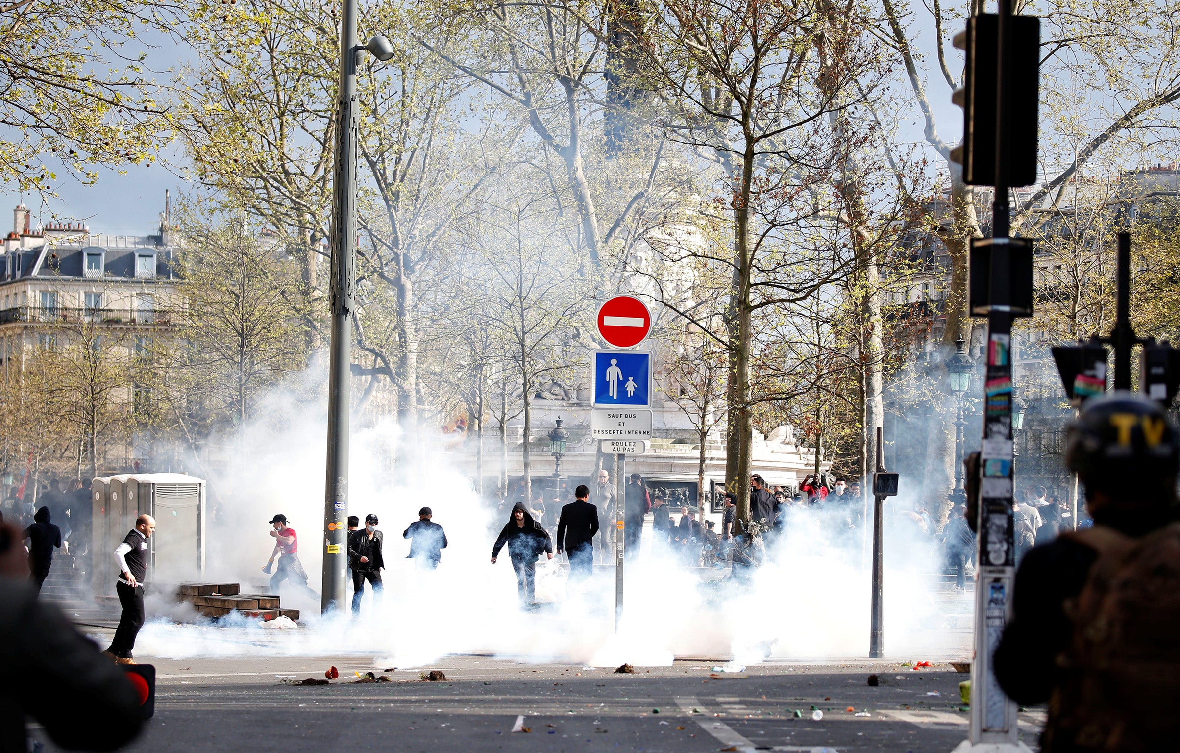 Clouds of tear gas fill the Place de la Republique during clashes between French riot police and members of the Chinese community