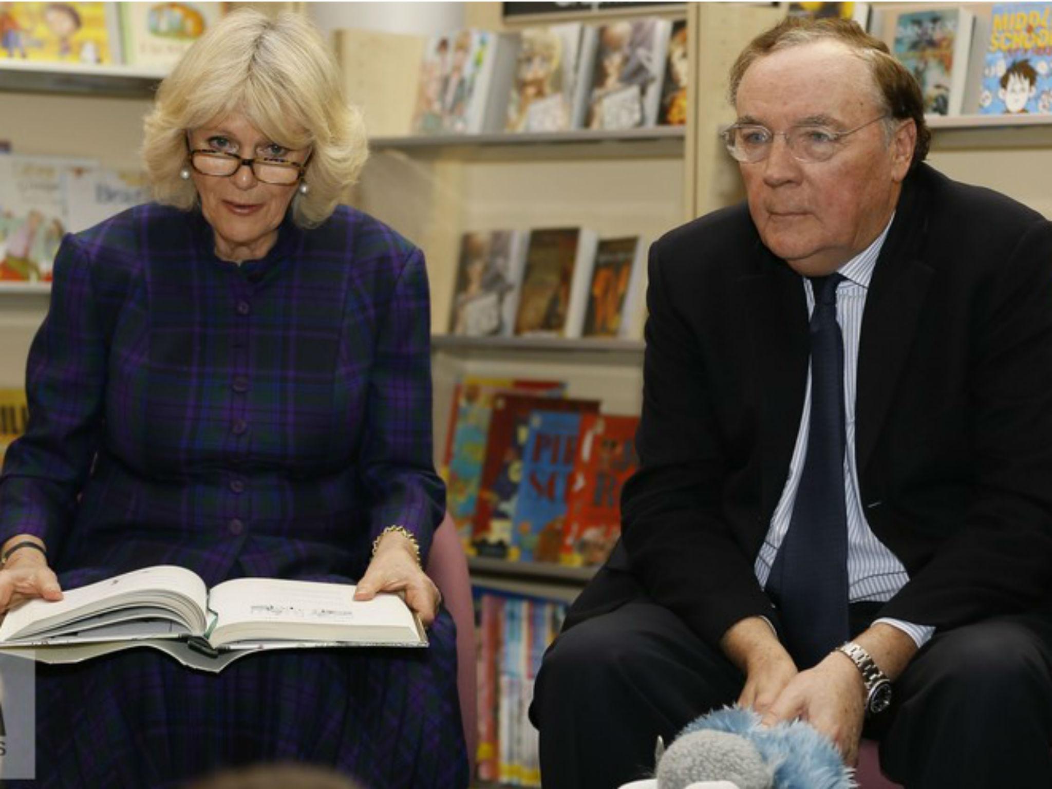 The Duchess of Cornwall and James Patterson read to children (Kirsty Wiggleworth/PA)
