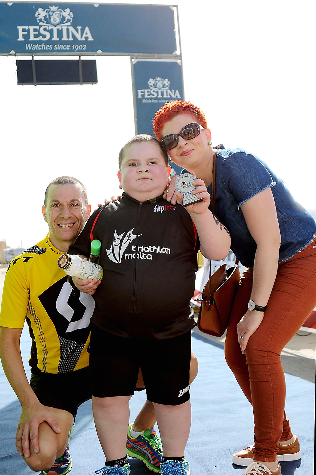 &#13;
Determined Jake, pictured with his parents, was diagnosed with ROHHAD, which causes sufferers to experience rapid weight gain, in 2015 &#13;